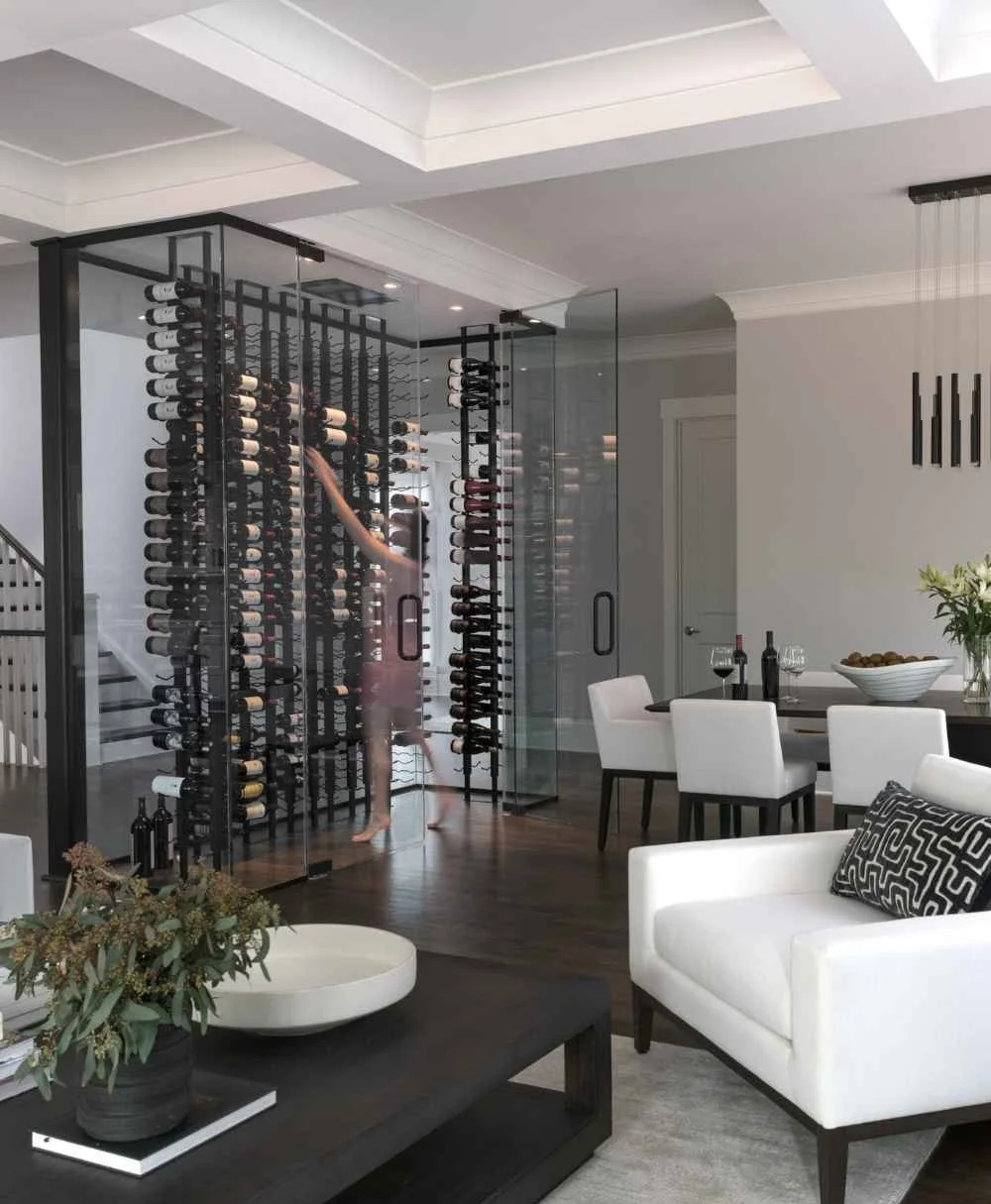 full-service-interior-design-charlotte-nc-roles-for-building-custom-home-woman-getting-bottle-of-wine-from-wine-room-rack-contemporary-new-build.jpg