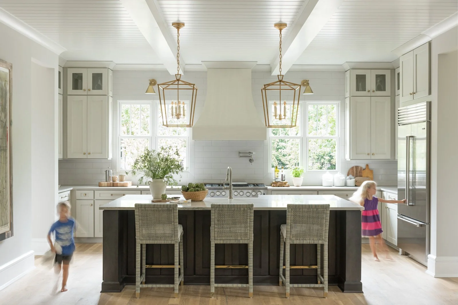 susan-hill-design-group-charlotte-nc-natural-vs-engineered-stone-kids-running-around-kitchen-island-light-bright-ceiling-beams-sophisticated-home.jpg