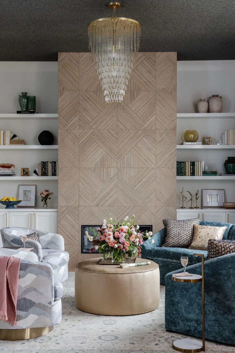 susan-hill-design-group-charlotte-nc-layered-lighting-design-living-room-with-statement-glass-light-fixture-contemporary-fireplace-curved-sofa-clean-home-furnishings.jpg