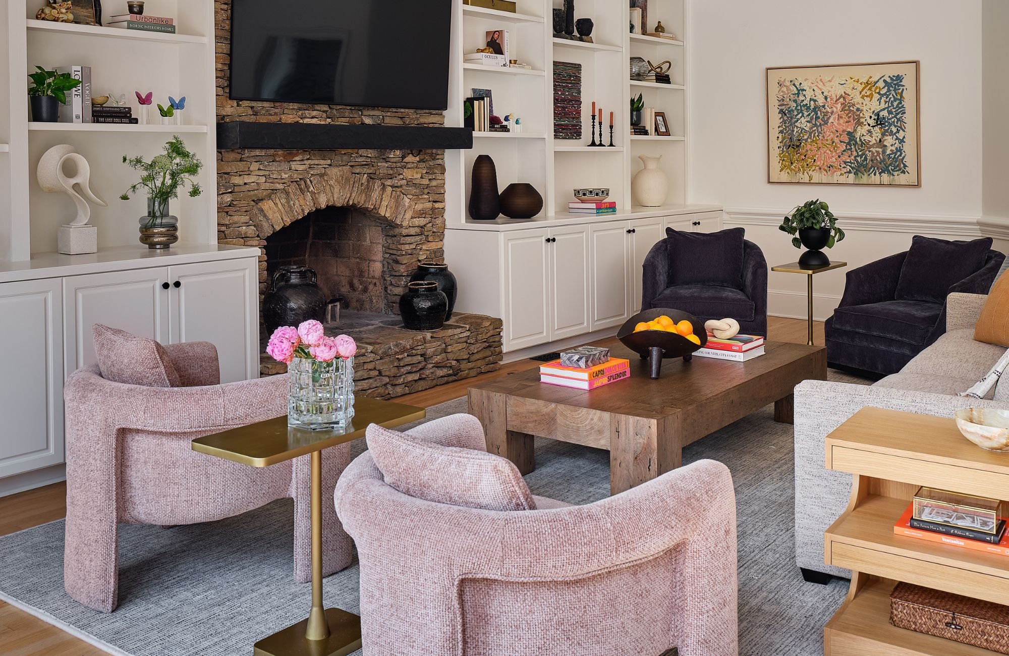 susan-hill-design-group-cornelius-nc-home-design-for-entertaining-living-room-with-curved-pink-chairs-built-in-cabinets-around-fireplace-family-life-renovation.jpg