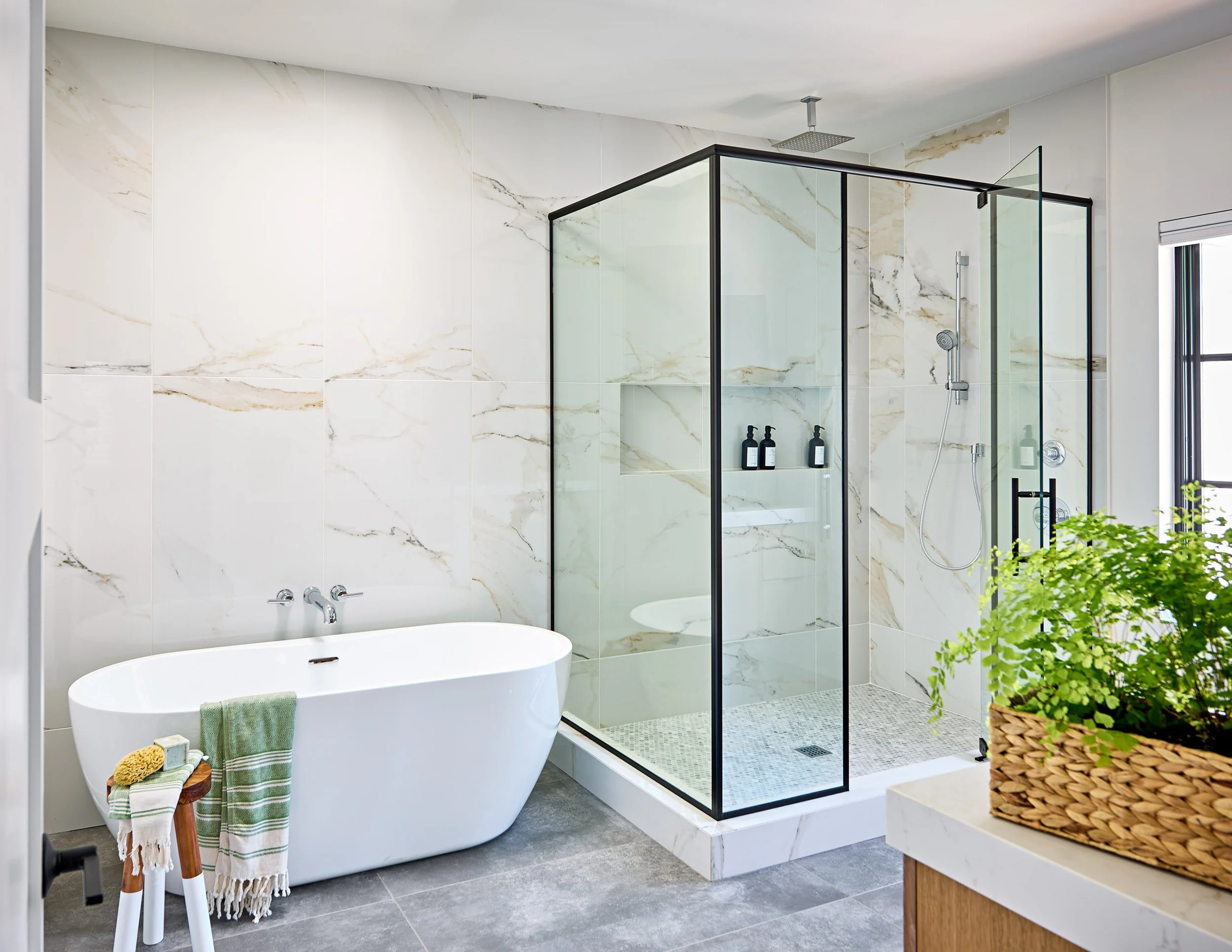 full-service-interior-design-columbia-sc-interior-design-misconceptions-bathroom-with-glass-shower-and-soaking-tub-slab-stone-wall-family-life.jpg