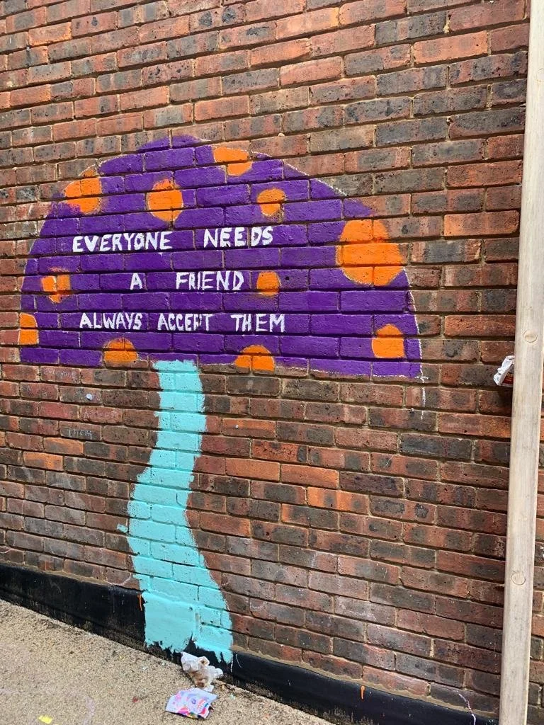 A painting of a mushroom which reads 'everyone needs a friend always accept them'