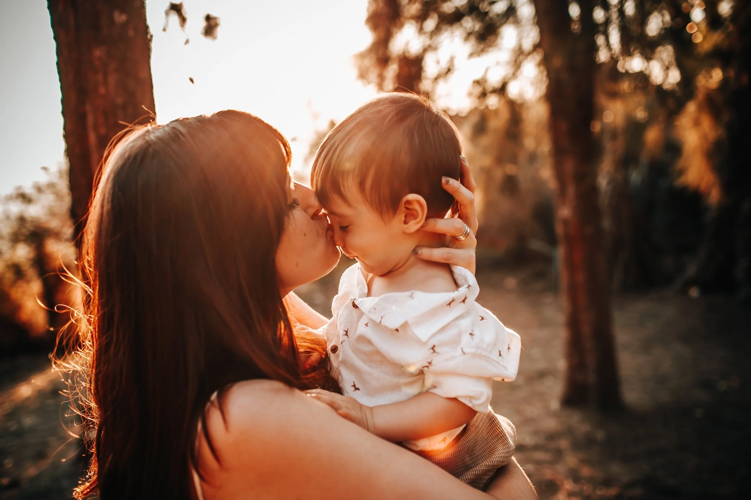 Mother and baby hugging in nature
