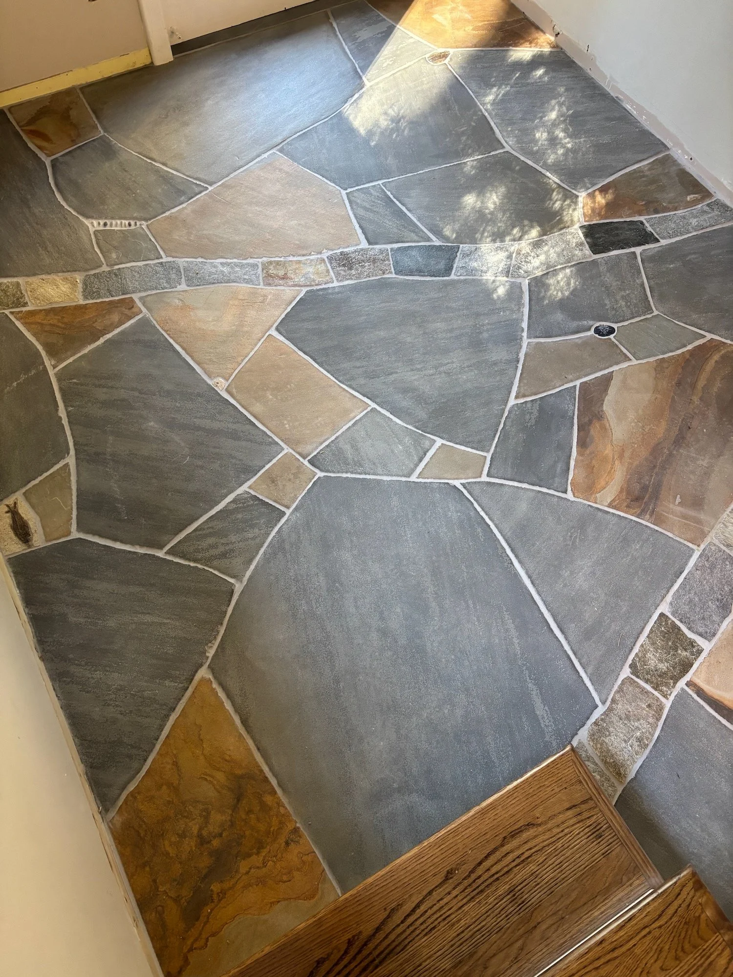 This 'Fossil Floor' in Biltmore Forest features a sandstone matrix, native stone branches and an array of fossils and other details