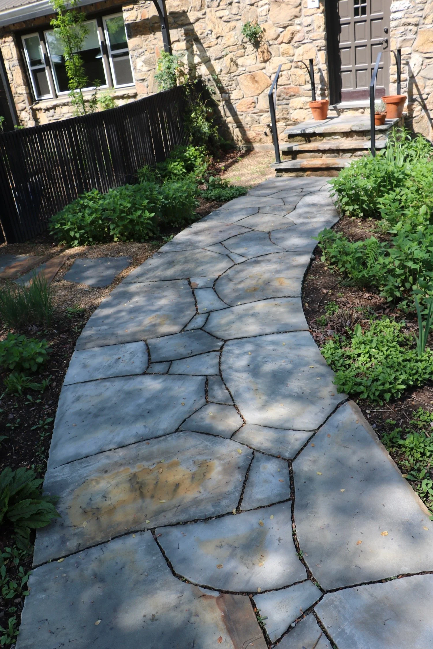 A wide path to a house made of local fieldstone. West Asheville