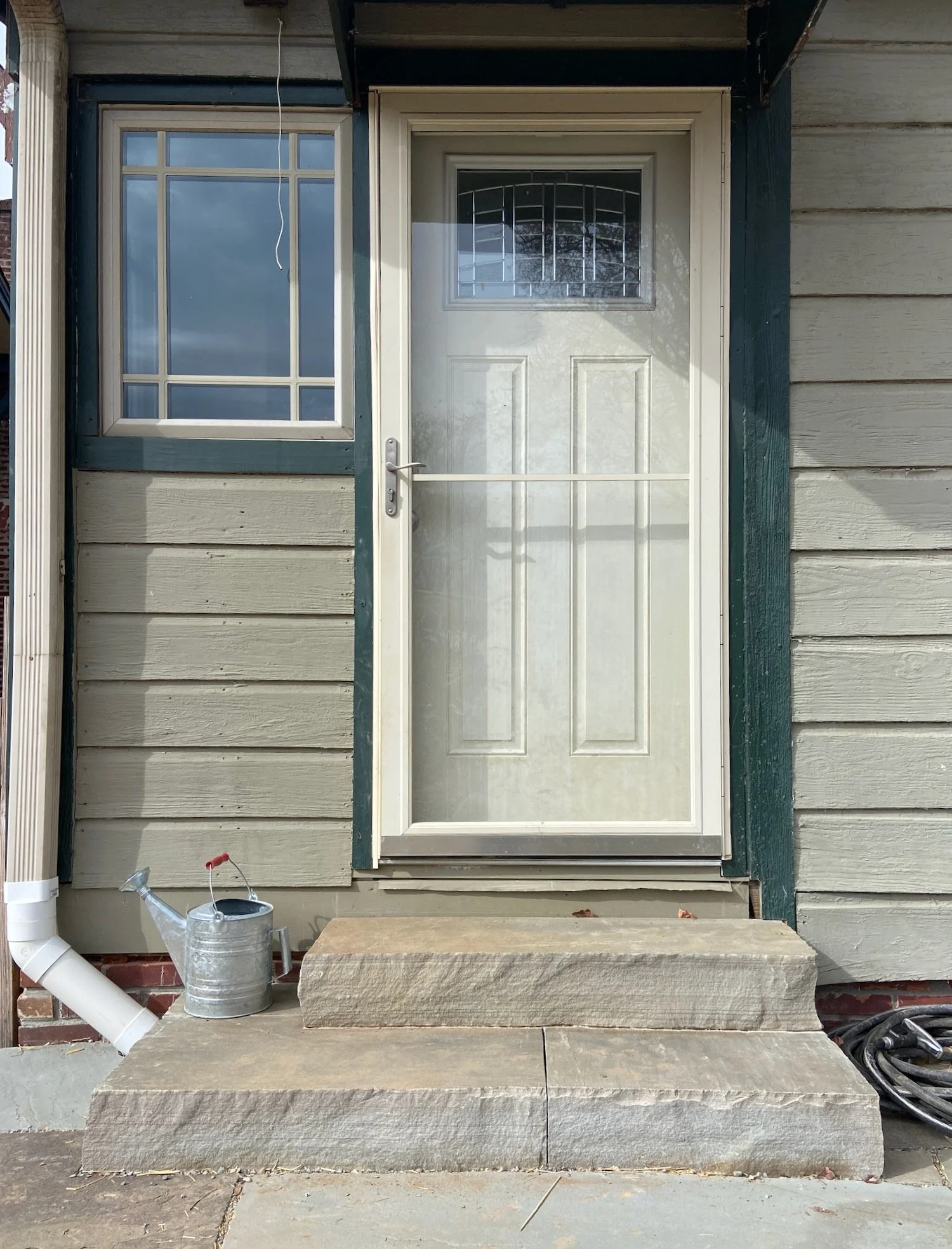 As is often the case, this back door is also the main door. The wider bottom step offers a place to stand while you fumble with your keys and a bag of groceries. West Asheville