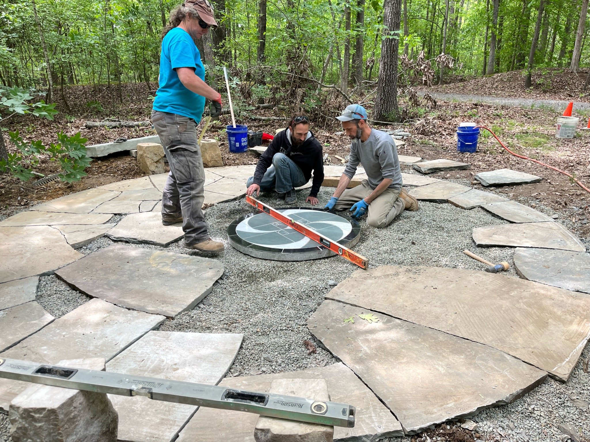 leveling the memorial mosaic in the stone patio
