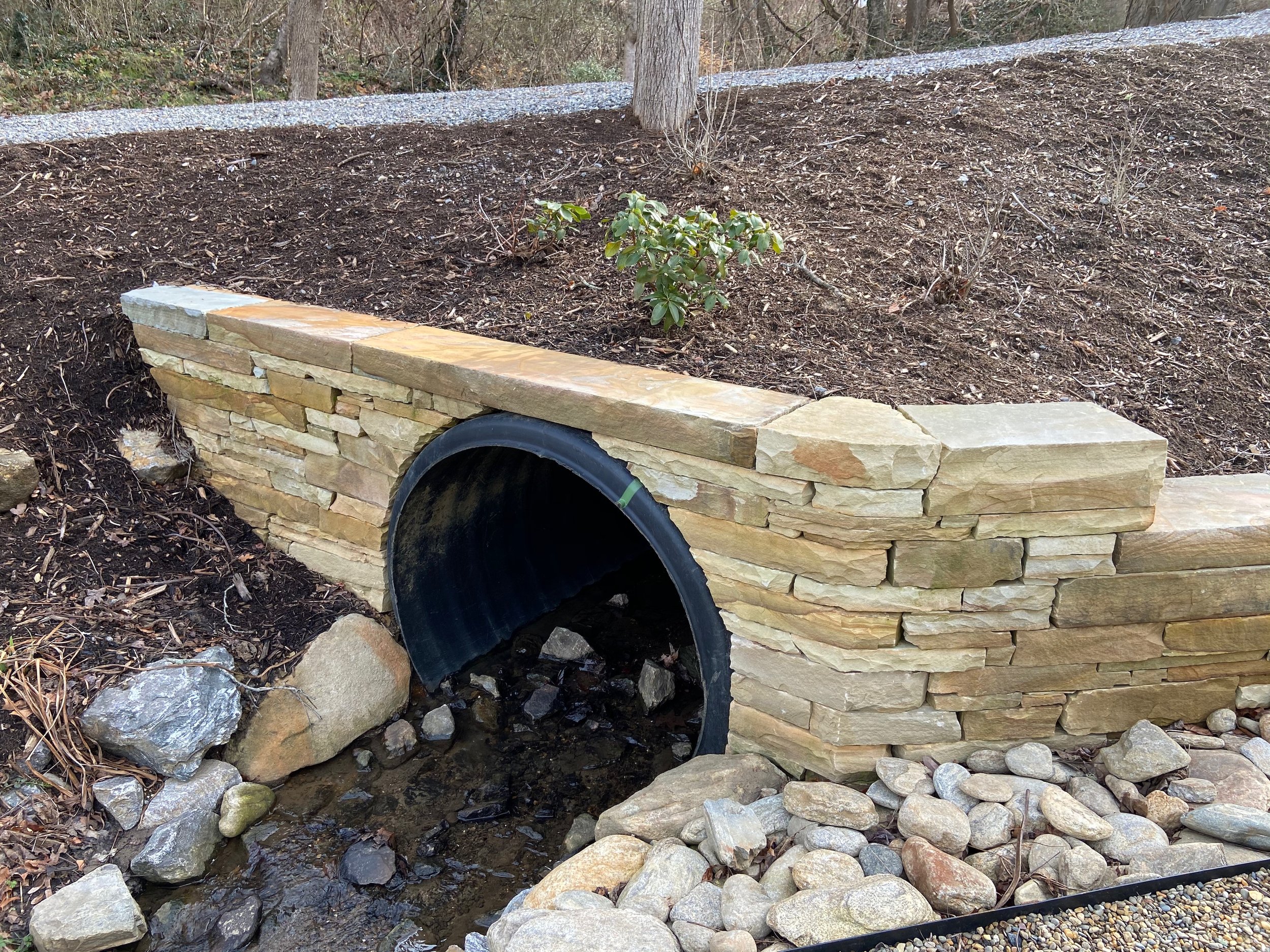 Drystone wall wraps culvert