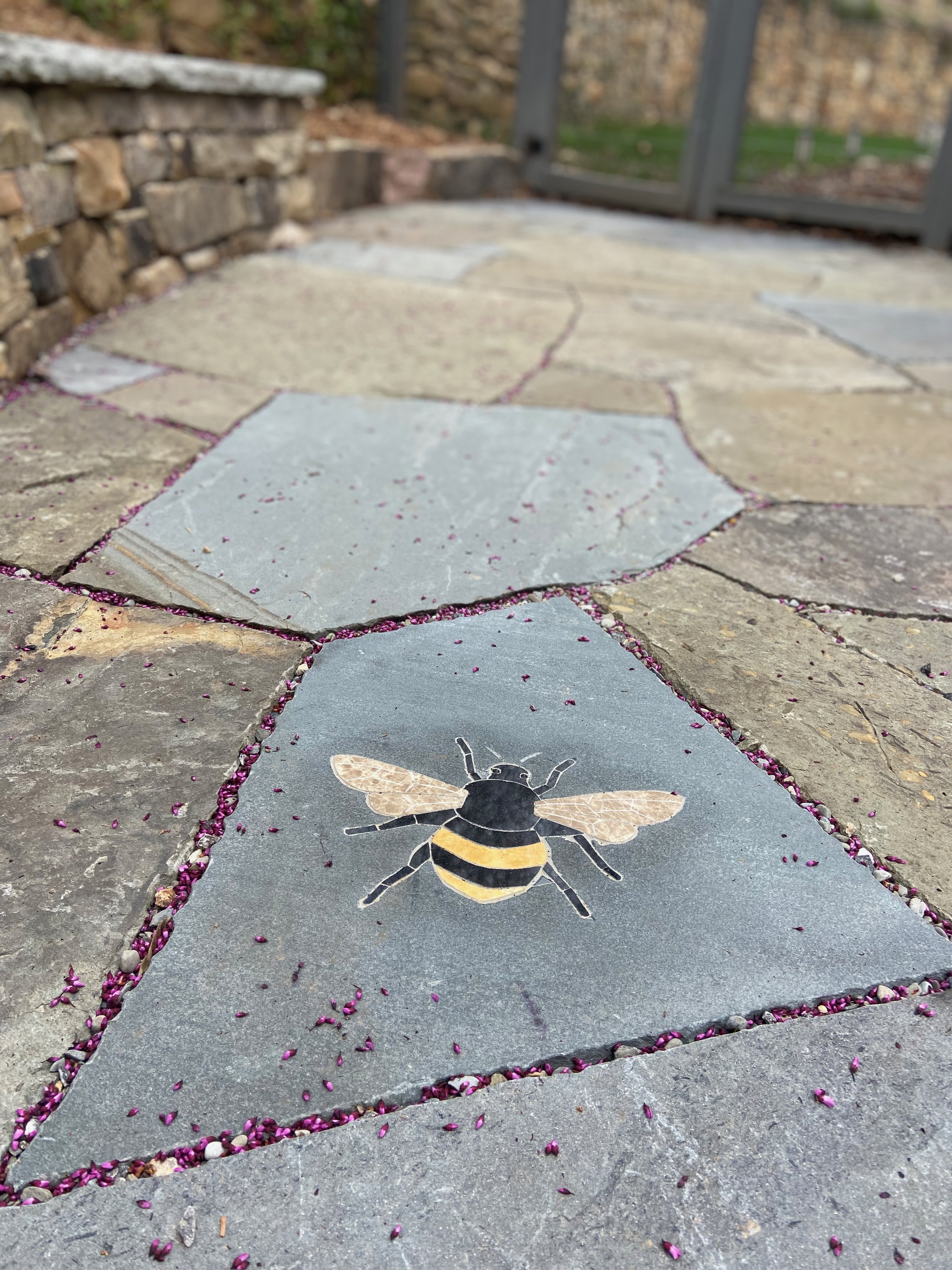 Mosaic bumblebee set into a stone patio