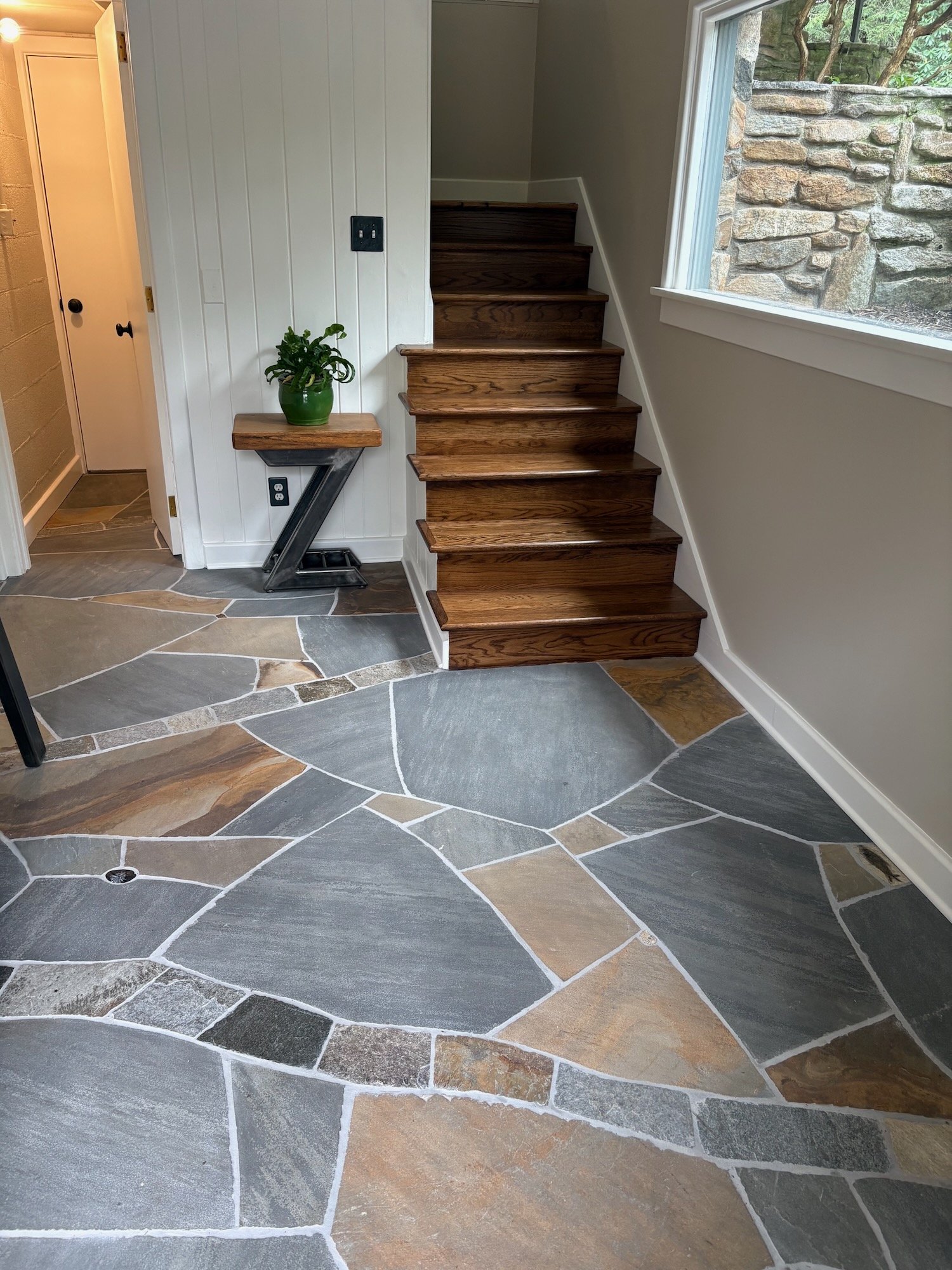 This 'Fossil Floor' in Biltmore Forest features a sandstone matrix, native stone branches and an array of fossils and other details