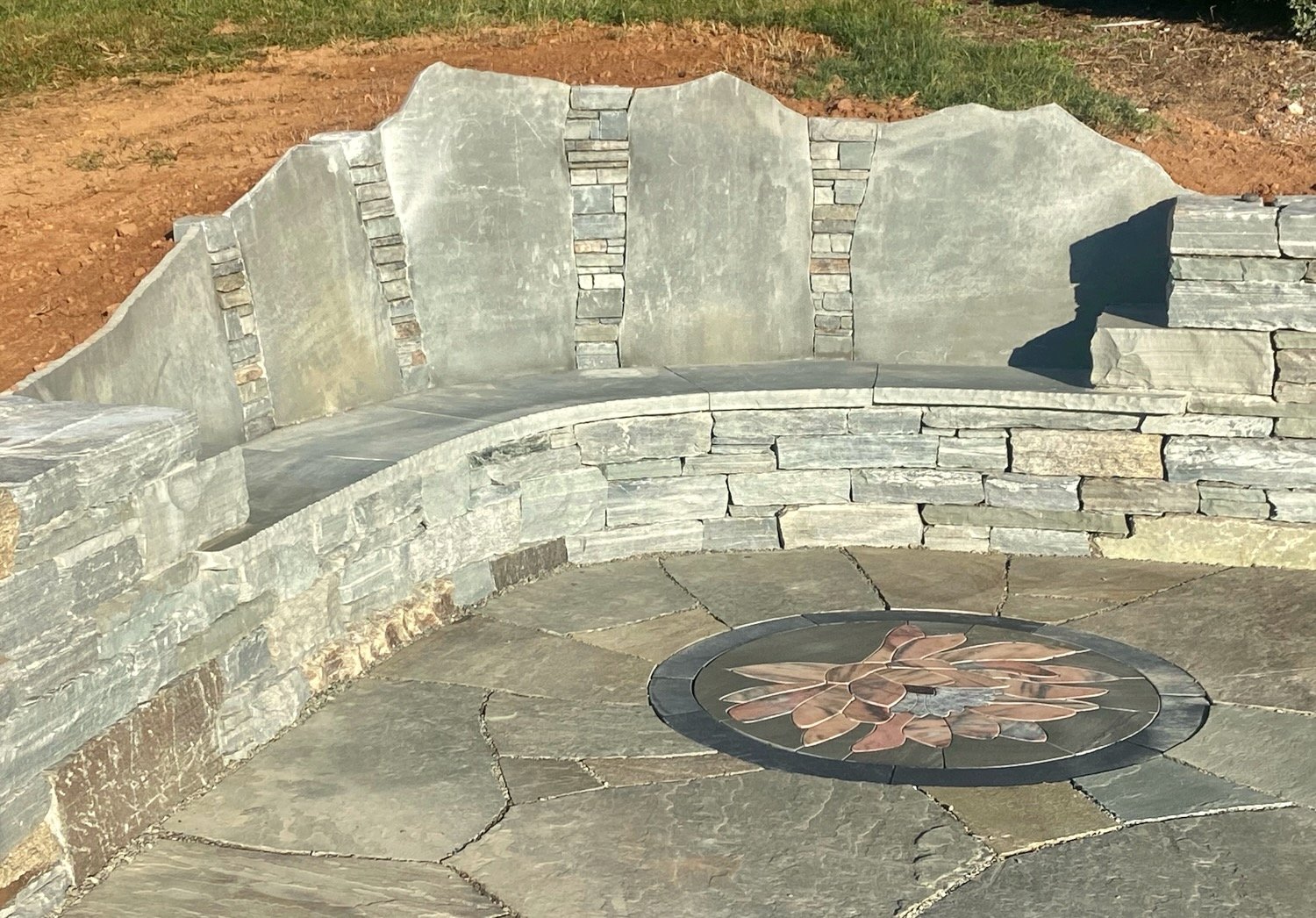  We created this patio, wall, bench, and lotus stone rug for a favorite client in Leicester.