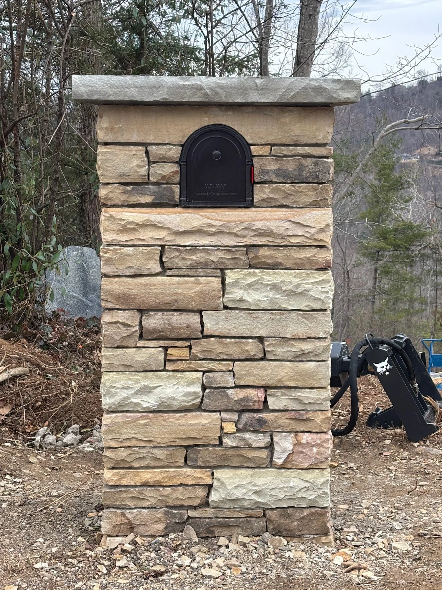 Mailbox column. Structural stone on a concrete footing.