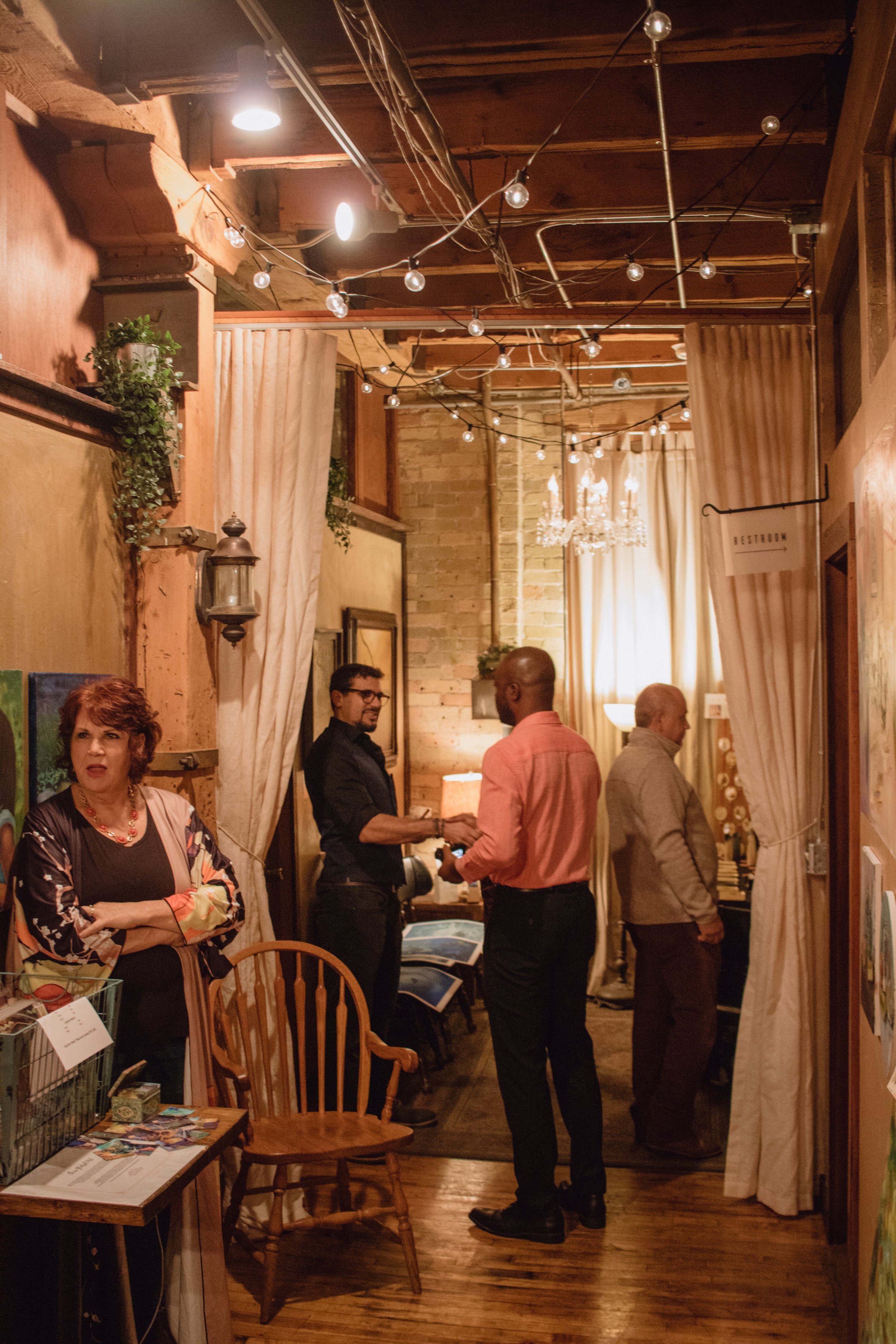  Painters  Alhaitham Jassar  and  Chris Glatzel  greet guests at Hygge: A Pop Up Gallery, curated by Milwaukee artist Lauren Marie Nitka, at  Glassnote Candle Bar . 