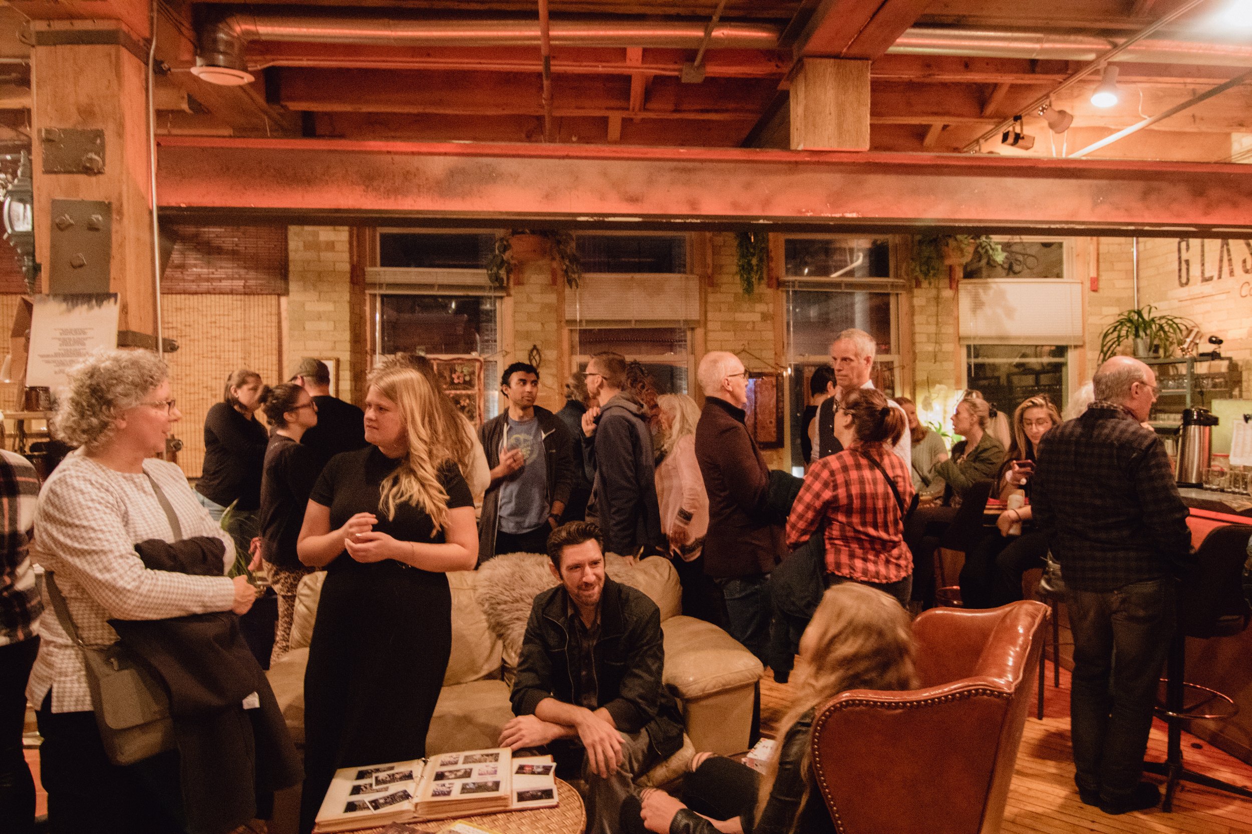  Writer Alycia Johnson of  Tirzah Magazine  talks with guests in seating area at Hygge: A Pop Up Gallery, curated by Milwaukee artist, Lauren Marie Nitka, at  Glassnote Candle Bar , in Walker’s Point, WI. 