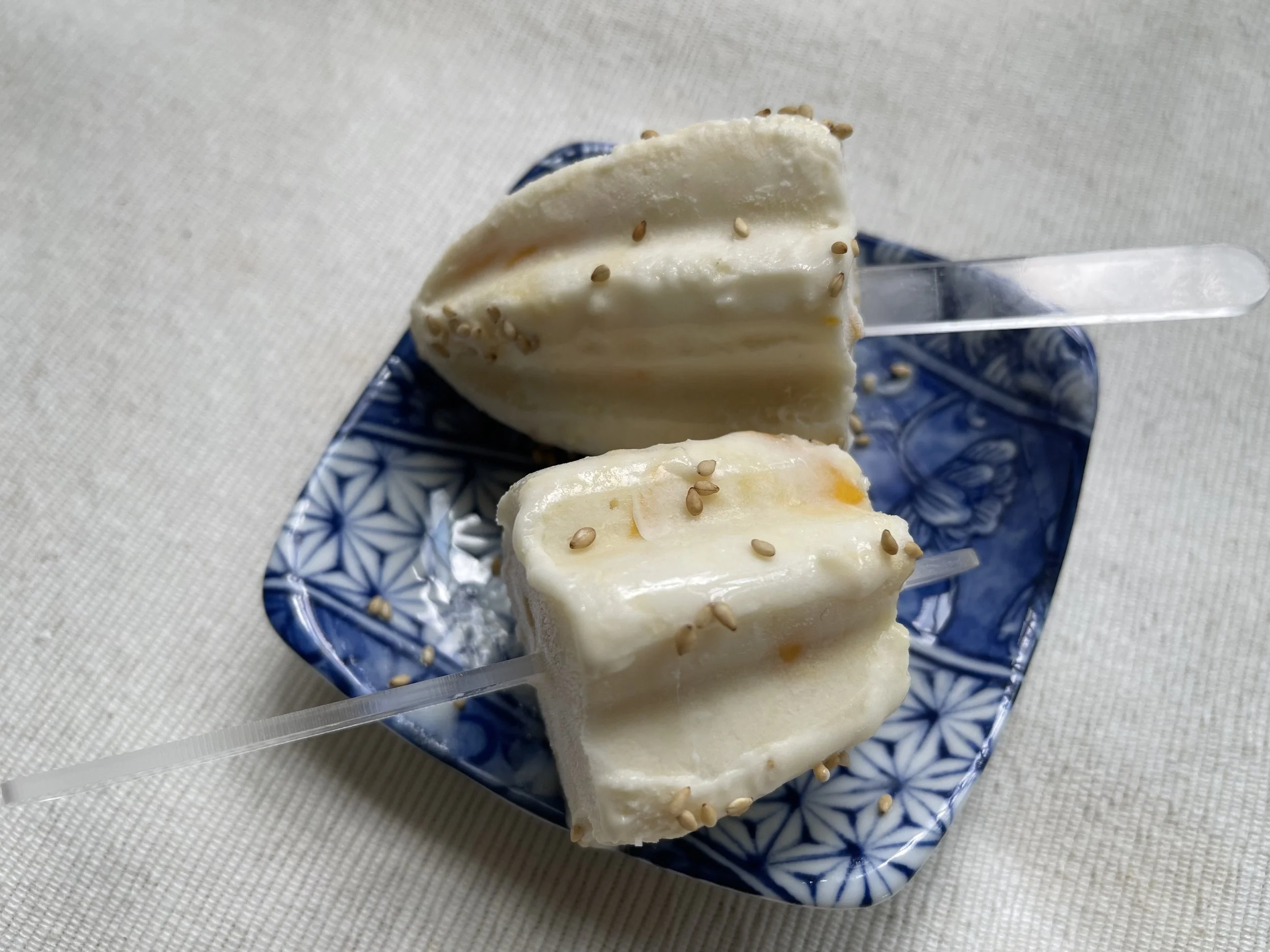 Mango sticky rice popsicles on blue plate