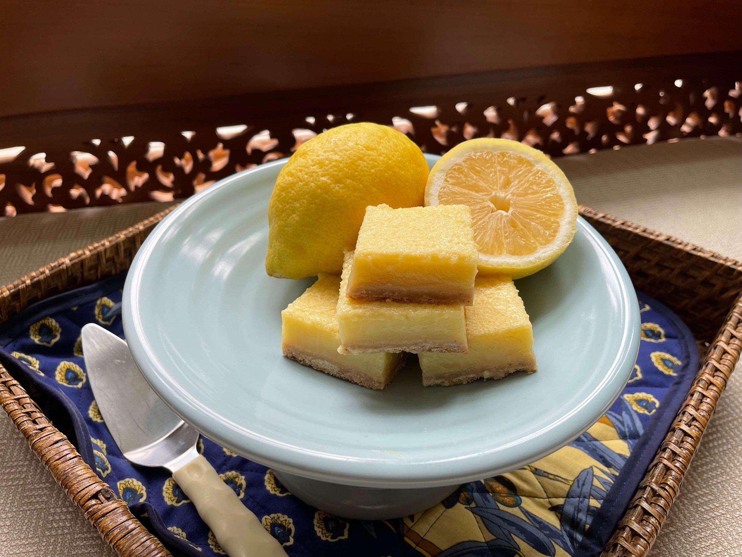 lemon bars and lemons on a plate