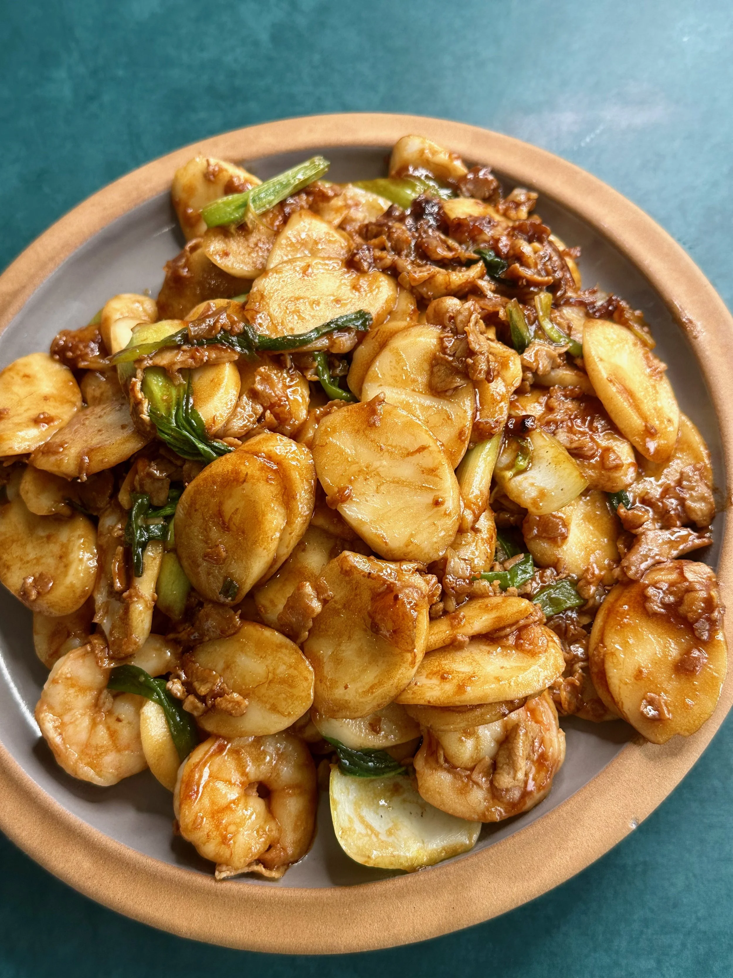 shanghai stir fried rice cakes in a shallow plate