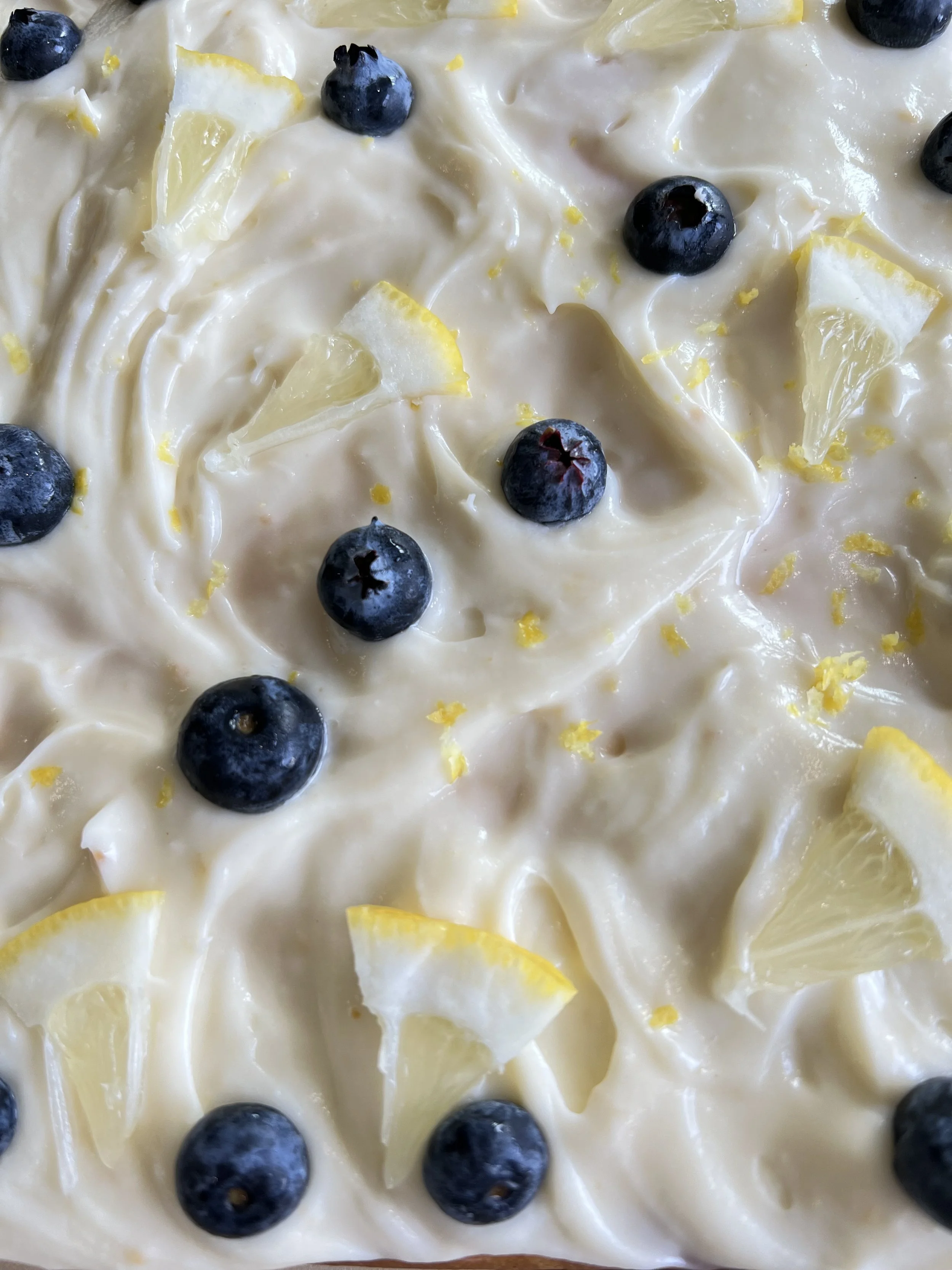 lemon mochi bar top down view with fresh blueberries and lemon slices
