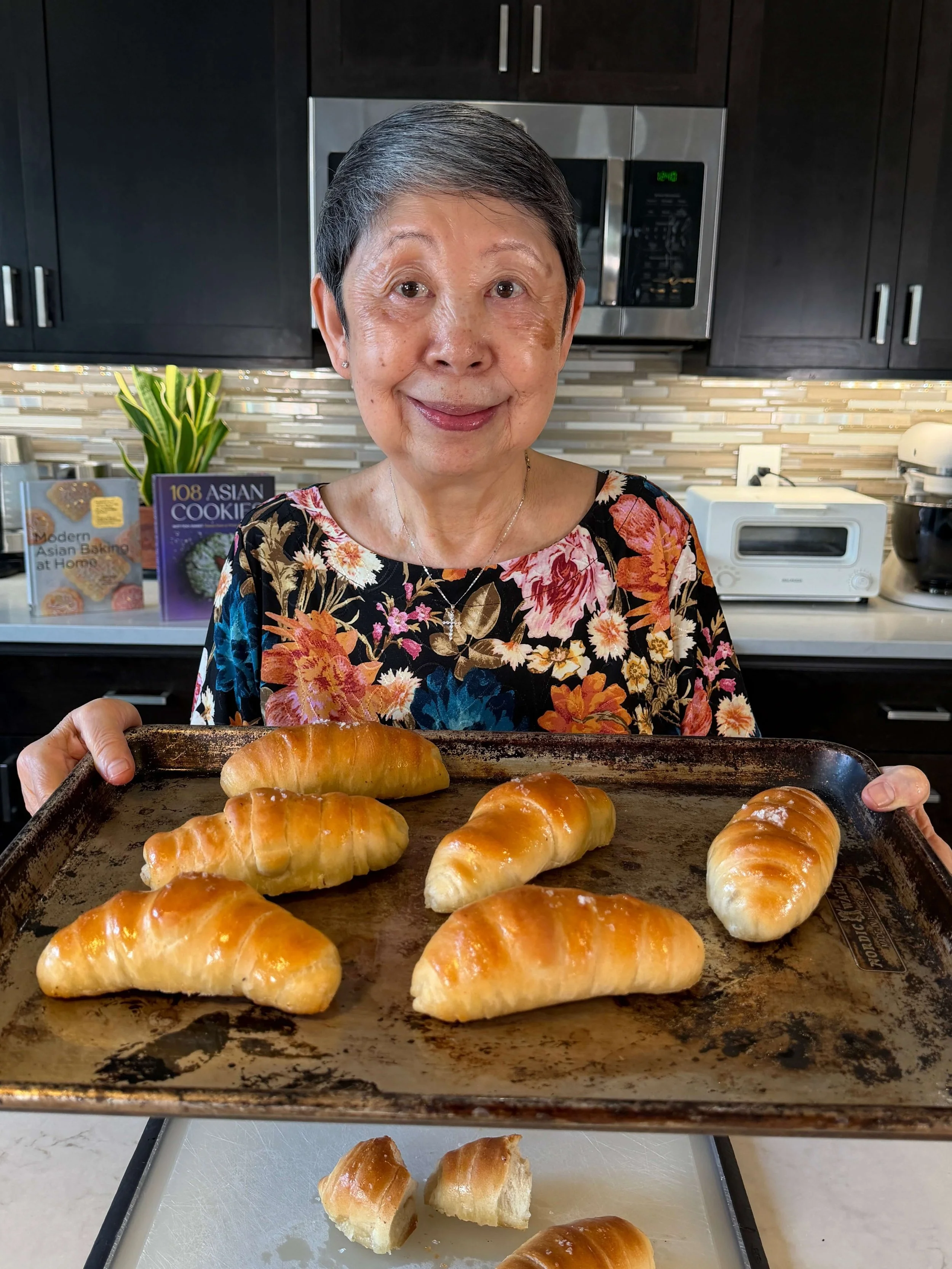 Mama Lieu holding tray of salt bread