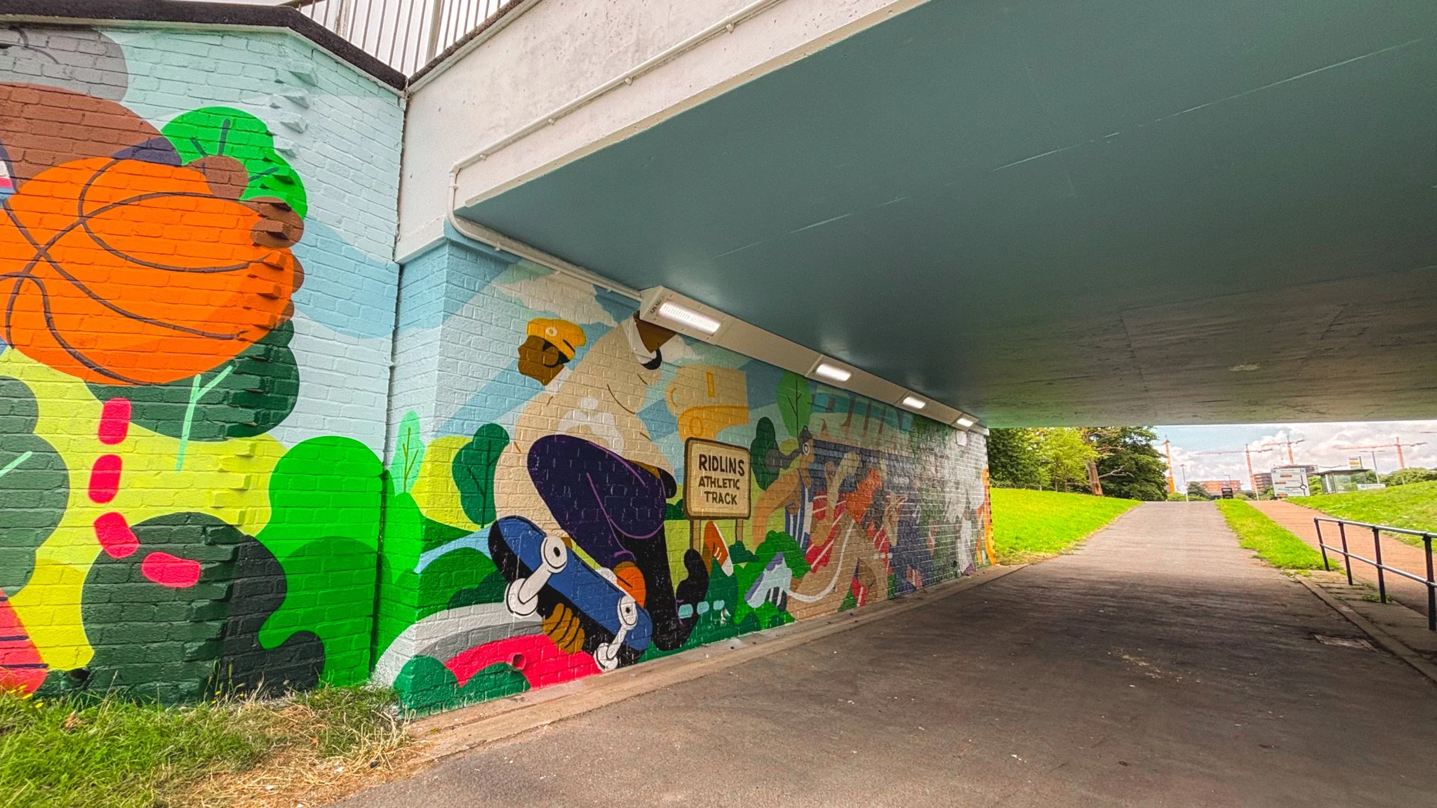 Stevenage underpass mural featuring dynamic colour, sport and community-led design.