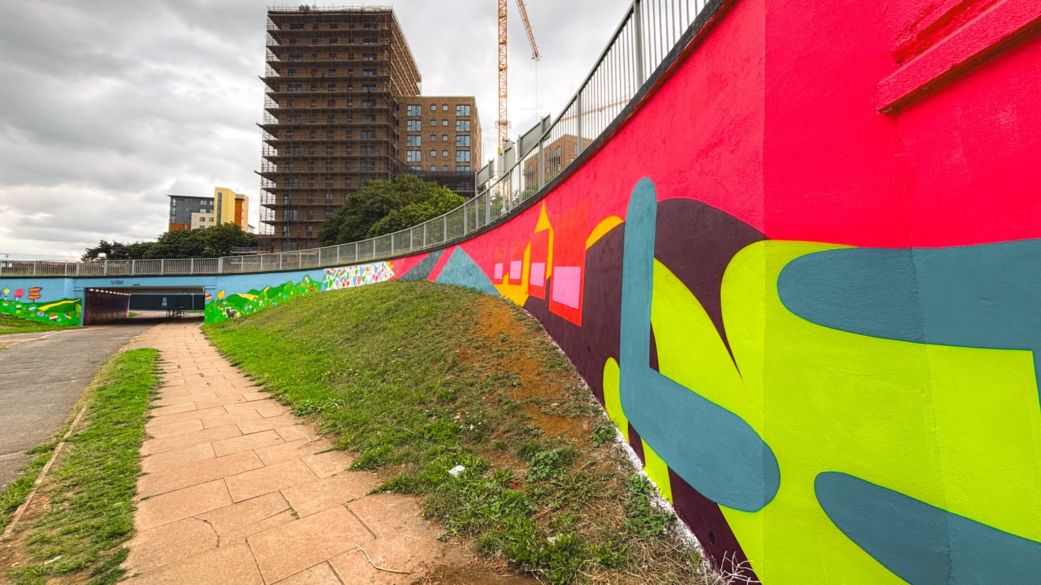 Large-scale mural artwork by Molly Hankinson transforming a Stevenage underpass into a celebration of female empowerment.