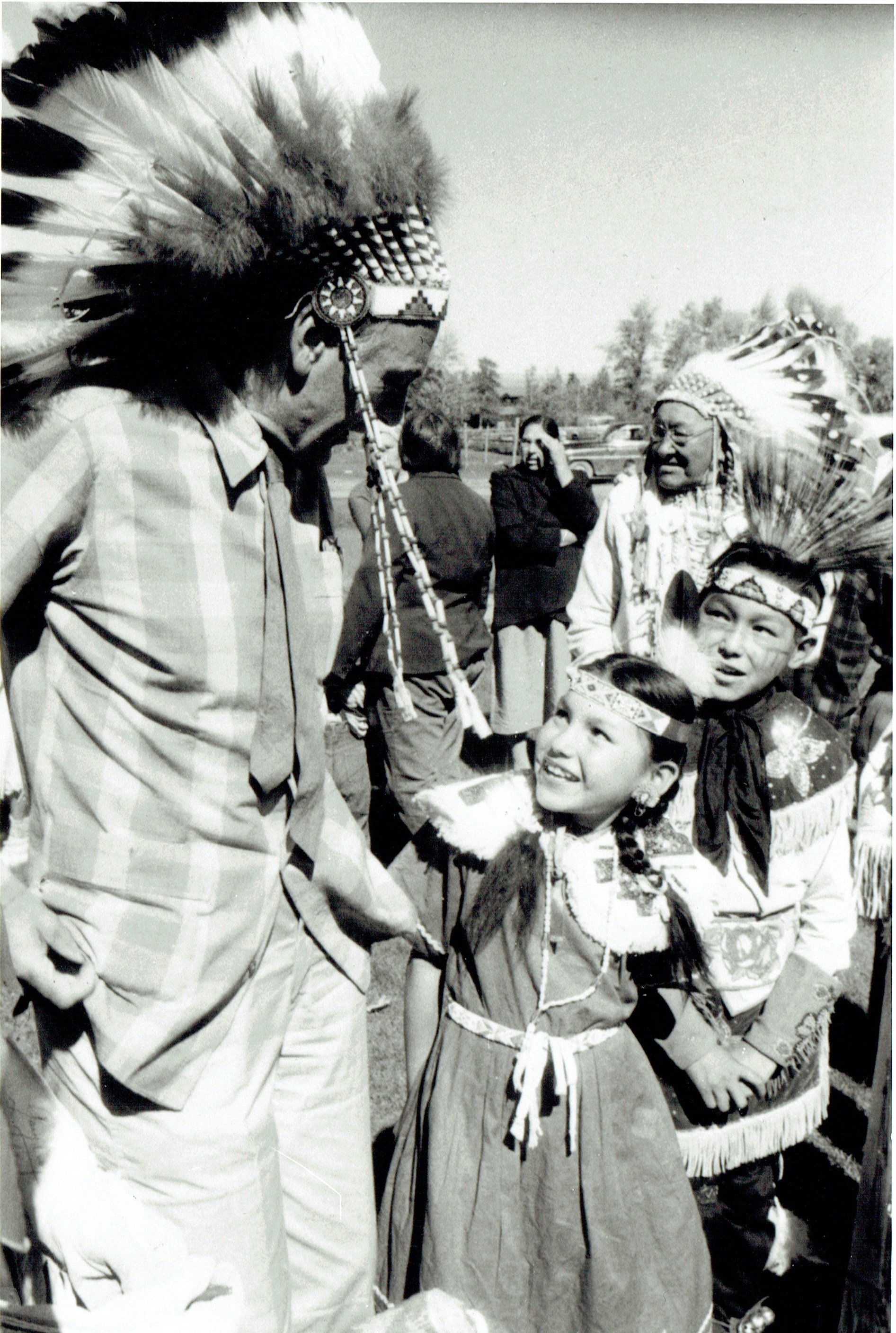 GC in Headdress with Native American Children.jpeg