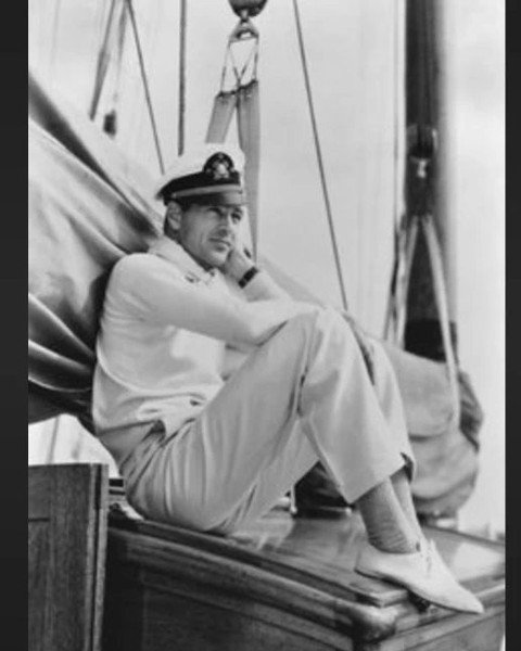 Ahoy, mateys! Set sail with us as we embark on a voyage into elegance with Gary Cooper. 🌊⚓ In this captivating shot, Cooper sits aboard a boat, the serene waters stretching out before him.

With his trademark charm and debonair demeanor, Cooper epit