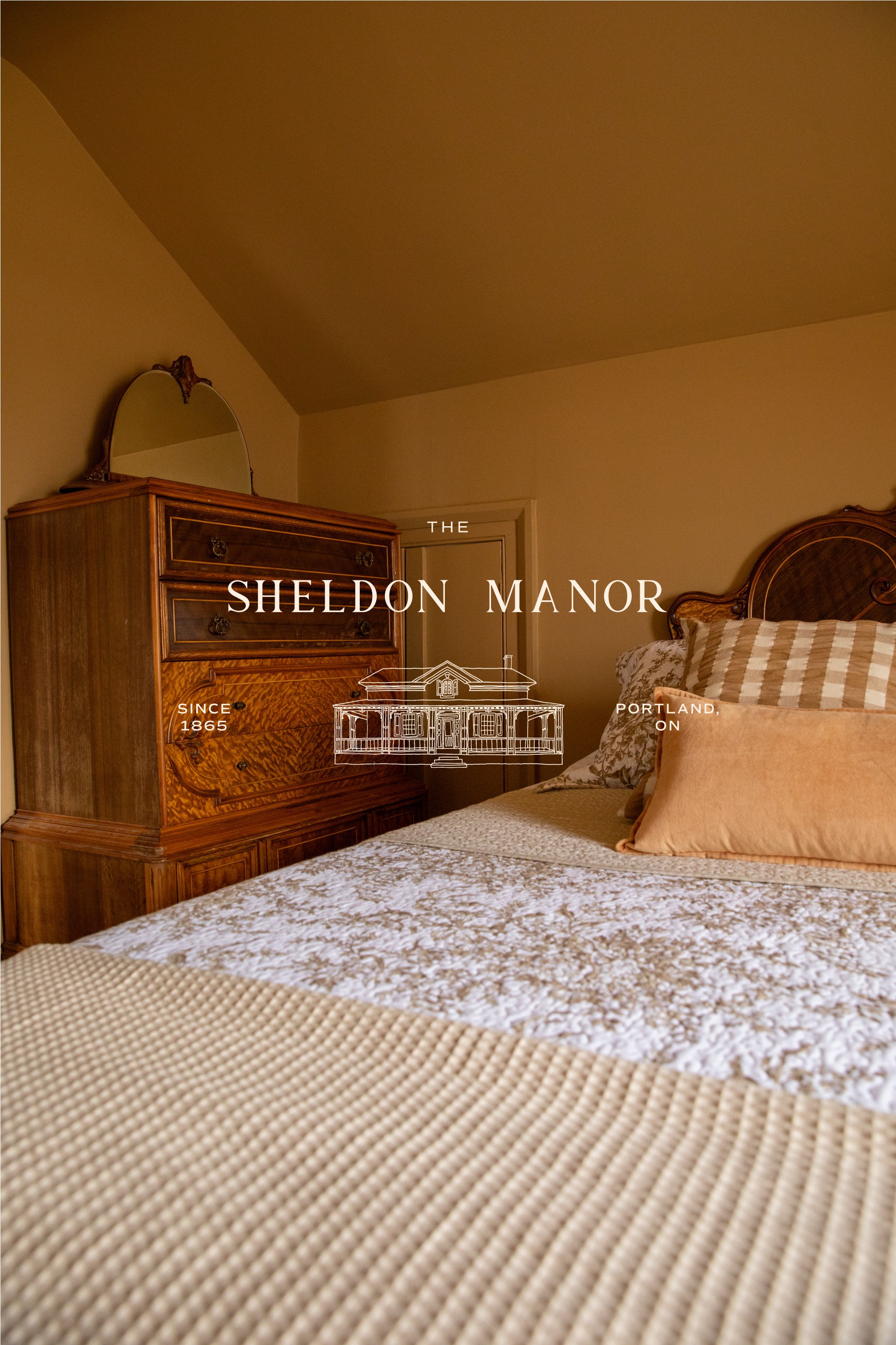 The Sheldon Manor luxury vacation rental bedroom featuring custom logo and illustrated heritage home branding