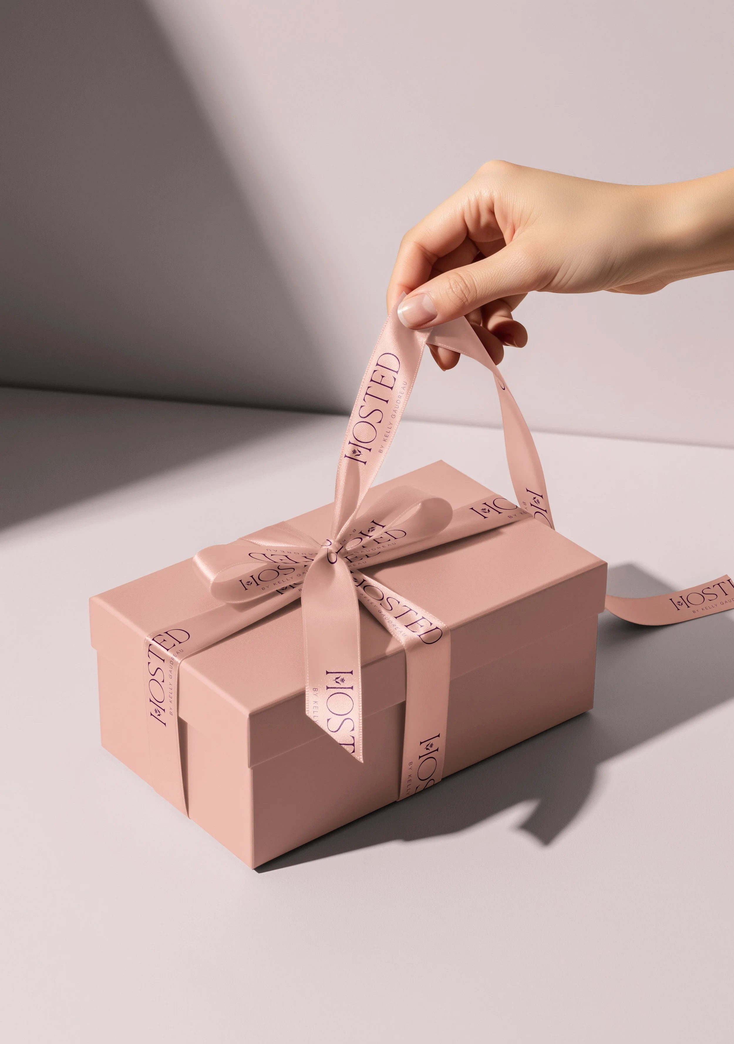 Hosted by Kelly Gaudreau branded gift packaging with custom pink ribbon for luxury gifting and registry experience