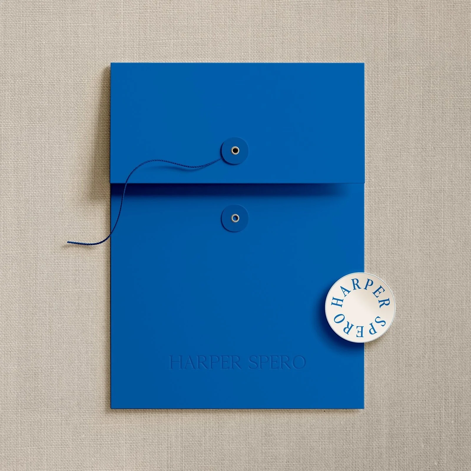 Harper Spero custom blue presentation folder and branded print collateral