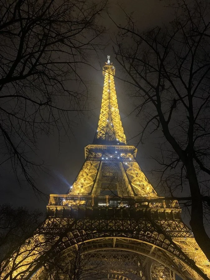 Illuminated Eiffel Tower in Paris, one stop on an AM|FM-planned family journey through London, Paris, and Rome.