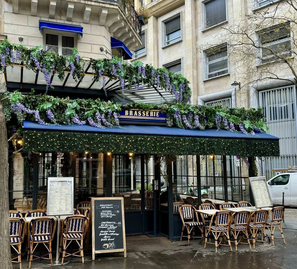 Flower-covered Paris brasserie photographed during an AM|FM Travel journey.