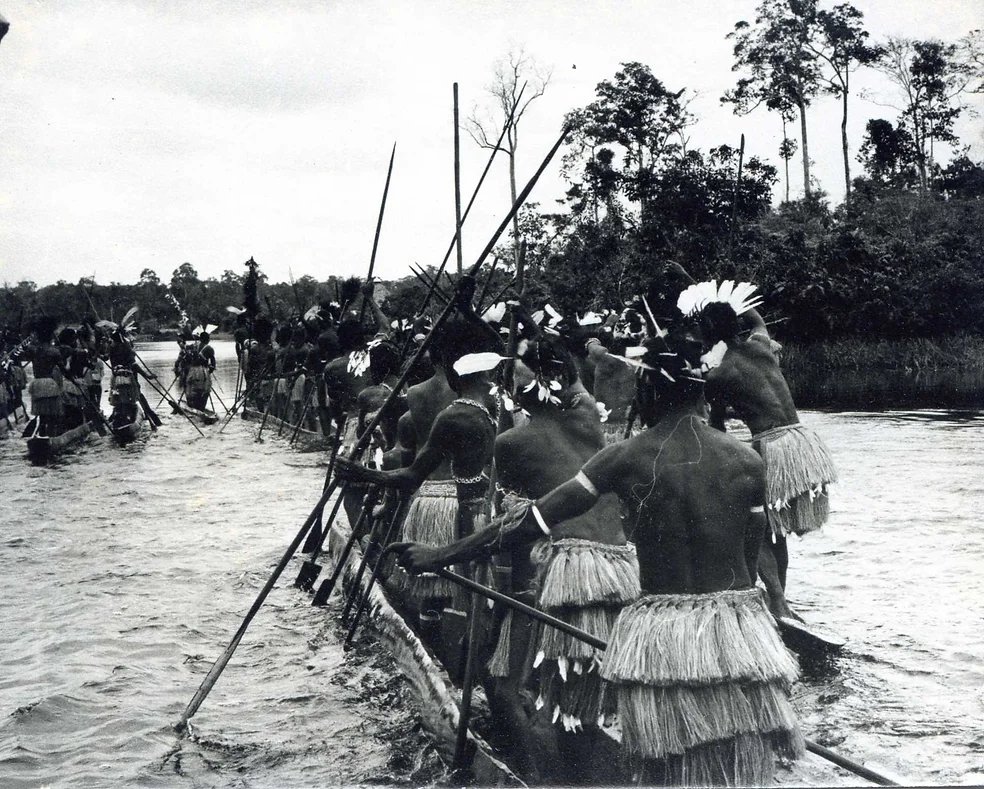 Sawi warriors on canoes