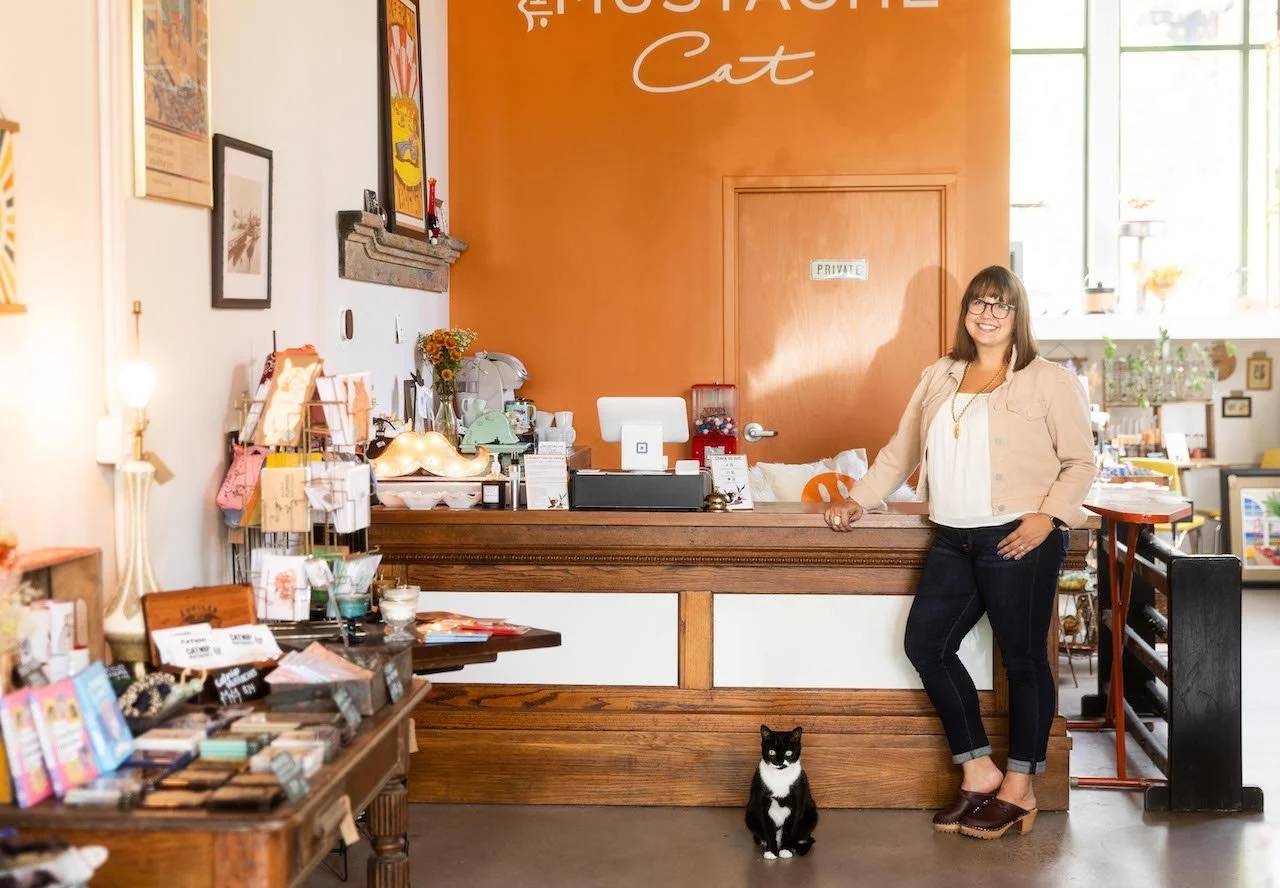 owner and shop cat in store