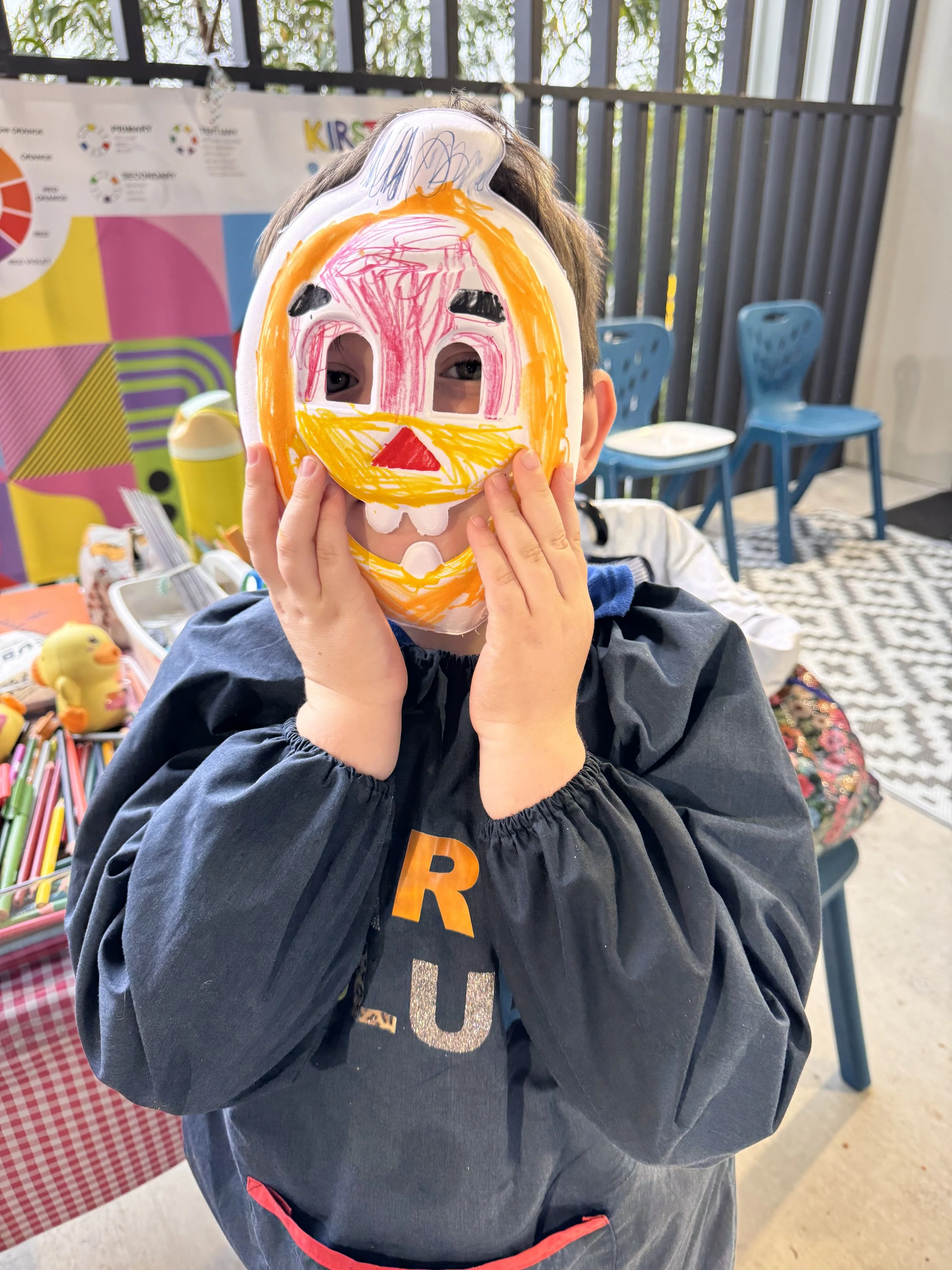 Kirstys Art & Craft Club child wearing pumpkin mask they made