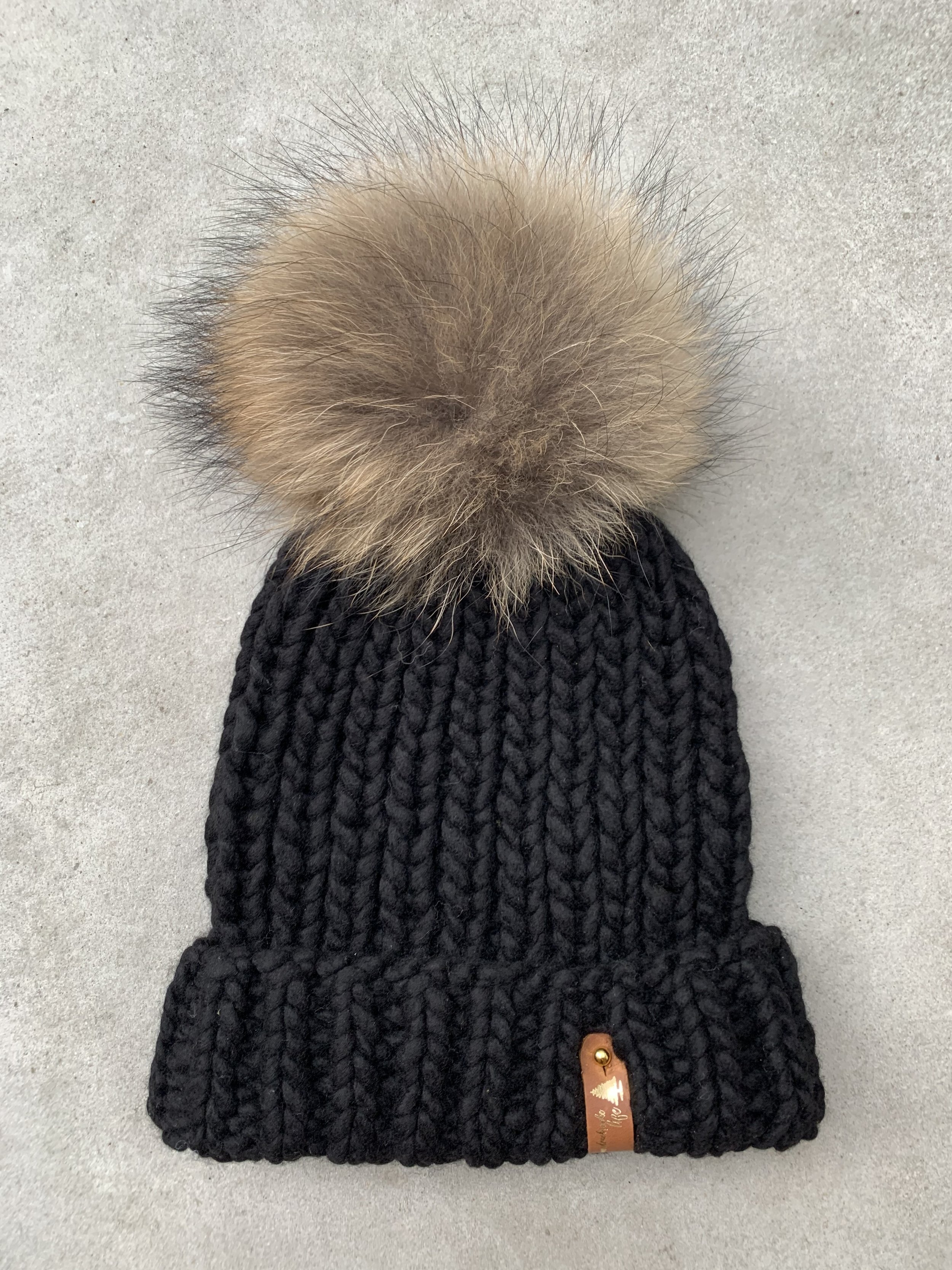 handknit black merino wool beanie with real fur pompom