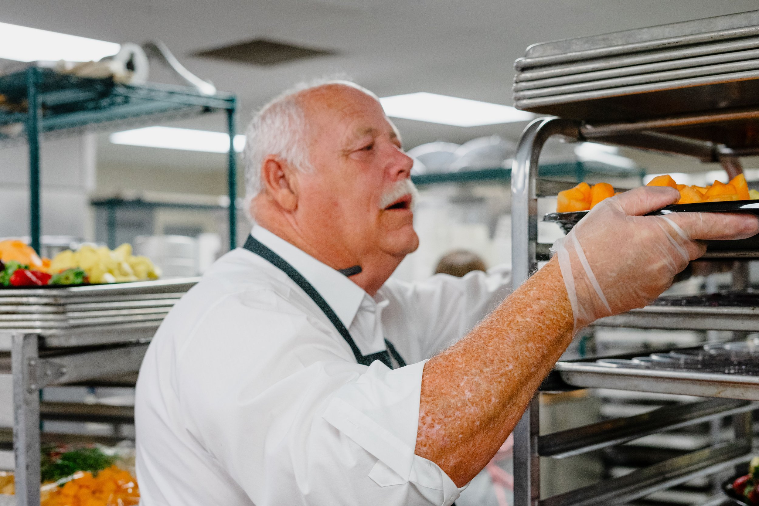 FDD volunteer preparing food trays