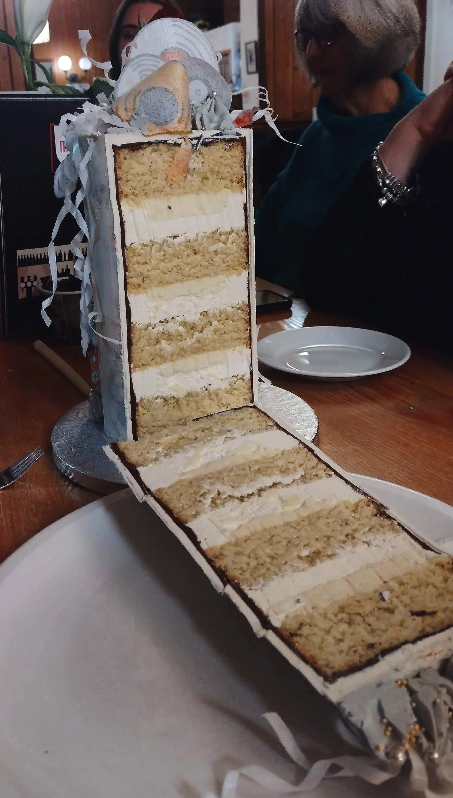 Layers of coconut, lime and cardamom sponge filled with two fillings of a lime vanilla Swiss meringue buttercream and a coconut white chocolate cremeux. 