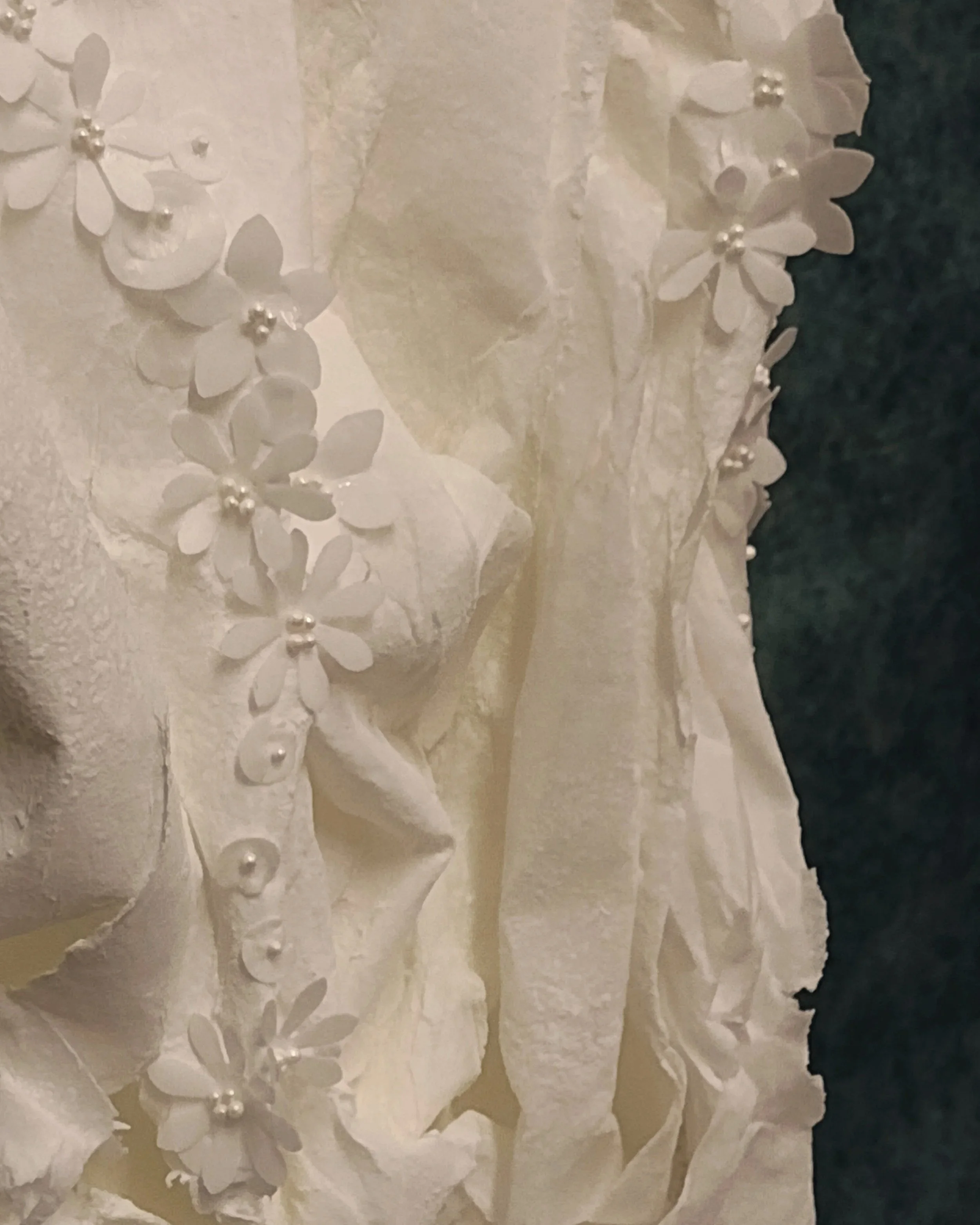 All edible sustainable garnish of sculptured wafer paper - giving the impression of a soft elegant feel of folded 'wedding dress' fabric and its delicate floral detail.