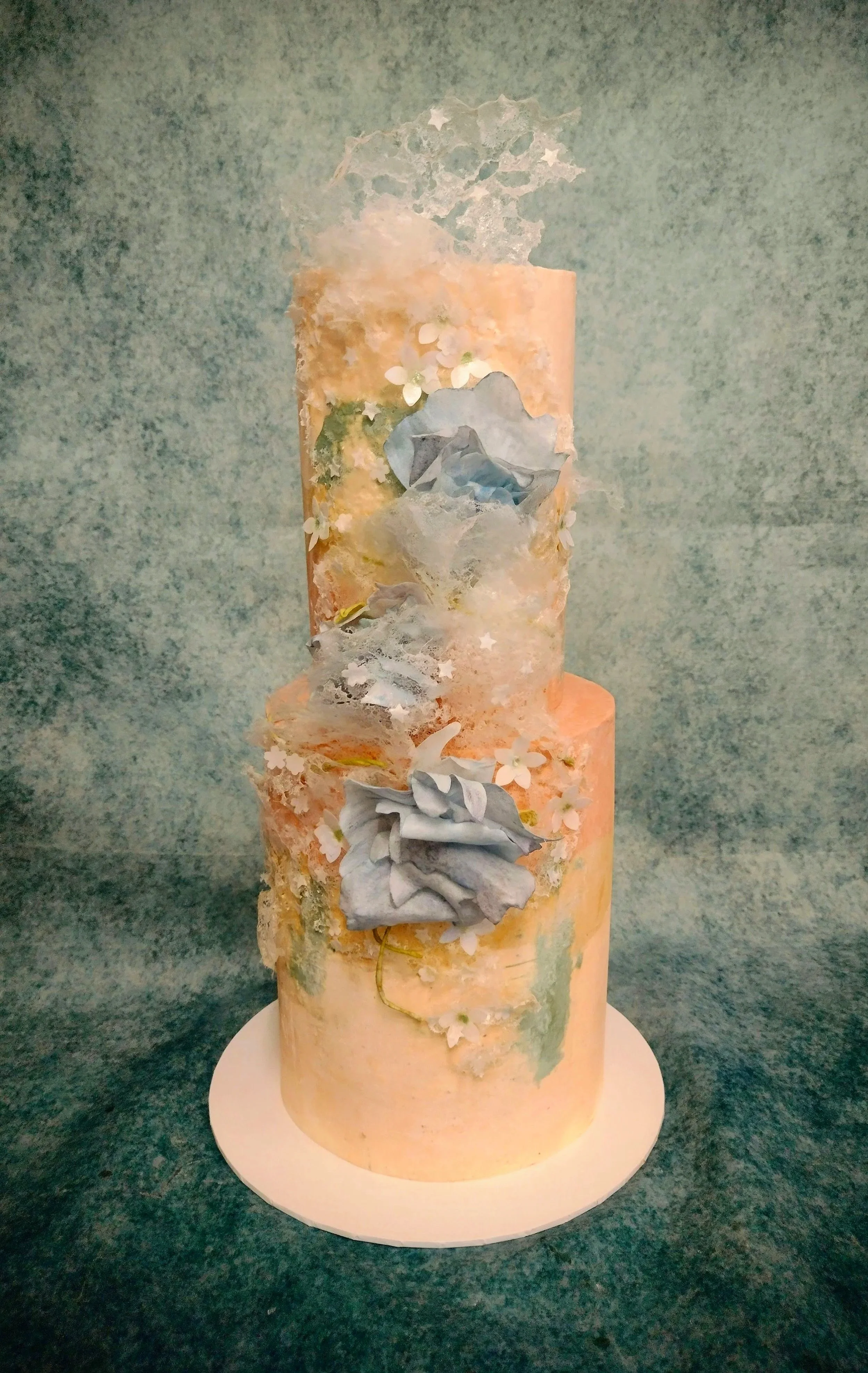 The bride and groom asked me to create a two tiered cake, with the sponge flavour being Pistachio and filled with a Raspberry compote and a vanilla Swiss meringue buttercream to compliment (sweet and silky) to the fruity tartness. Finished with an 'o