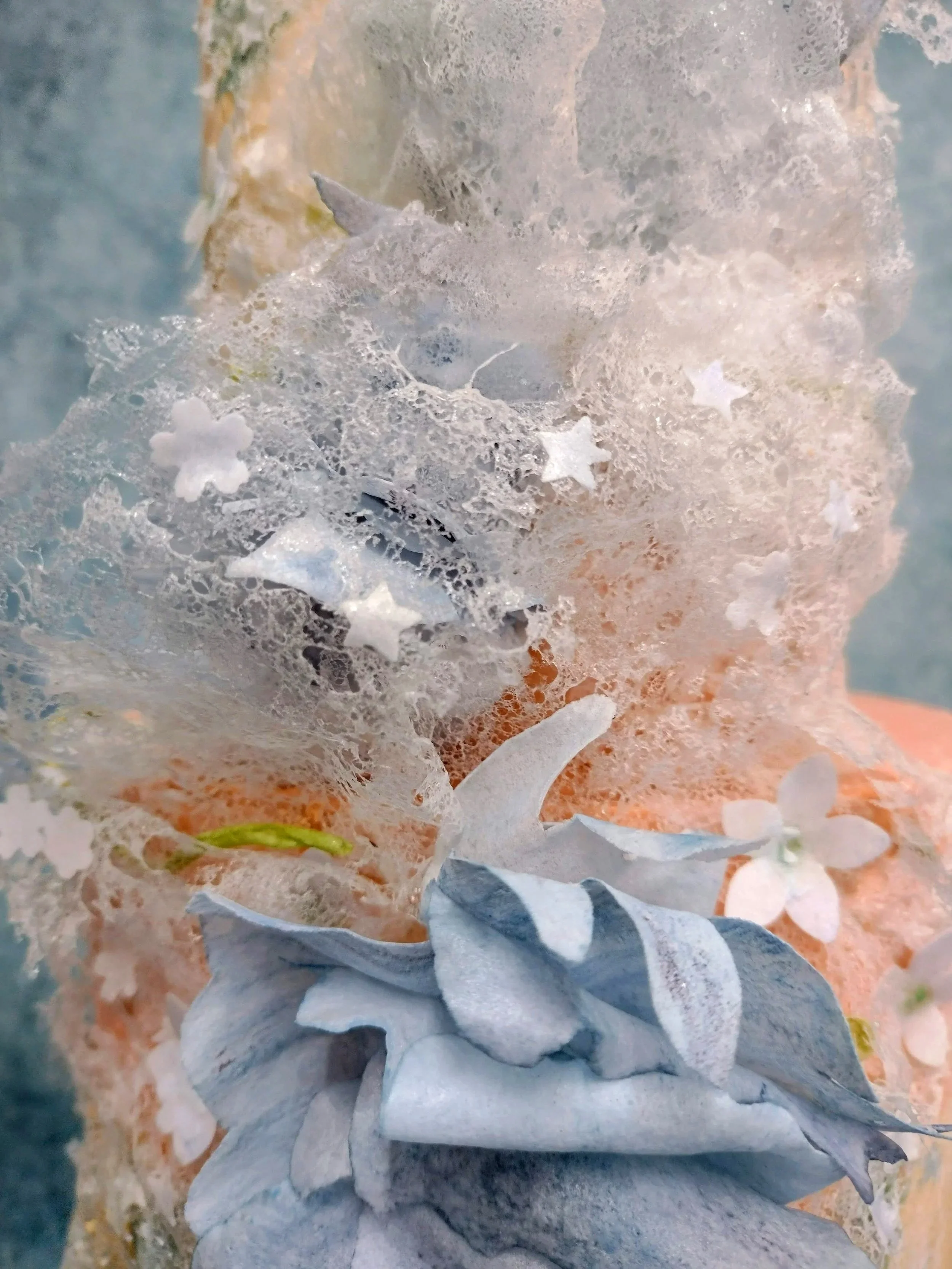 The delicate details of the decoration was to reflect the brides very own hand made veil. Lace embroidered with blue flowers, tiny white flowers with a subtle green centre, and a scattering of embroidered stars. Leading me to represent the brides vei