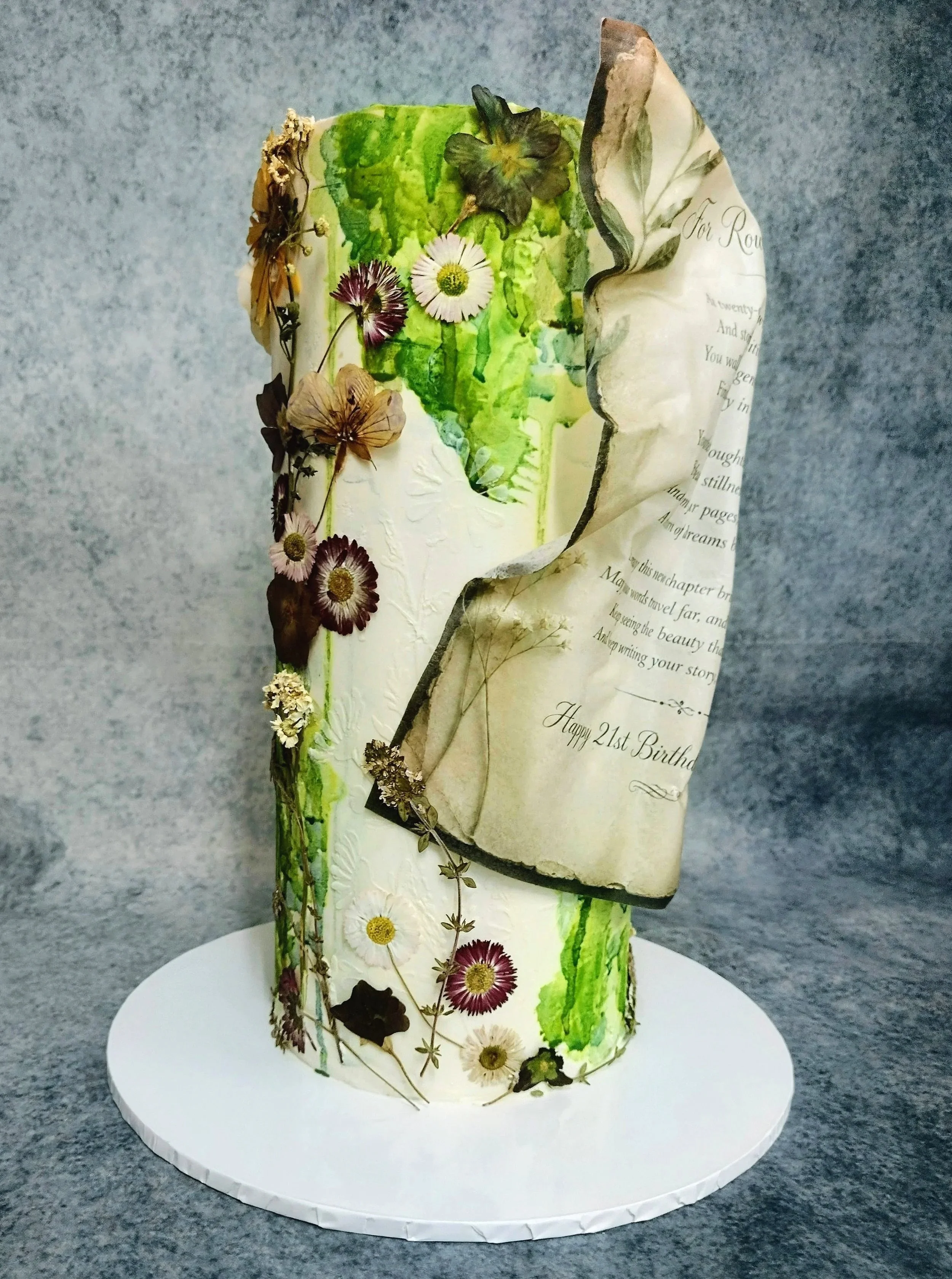 A 21st birthday cake, made from plant based ingredients throughout. I was requested to design and create a bespoke cake which highlights the birthday boys love of nature and his passion for poetry and writing in the finished design.