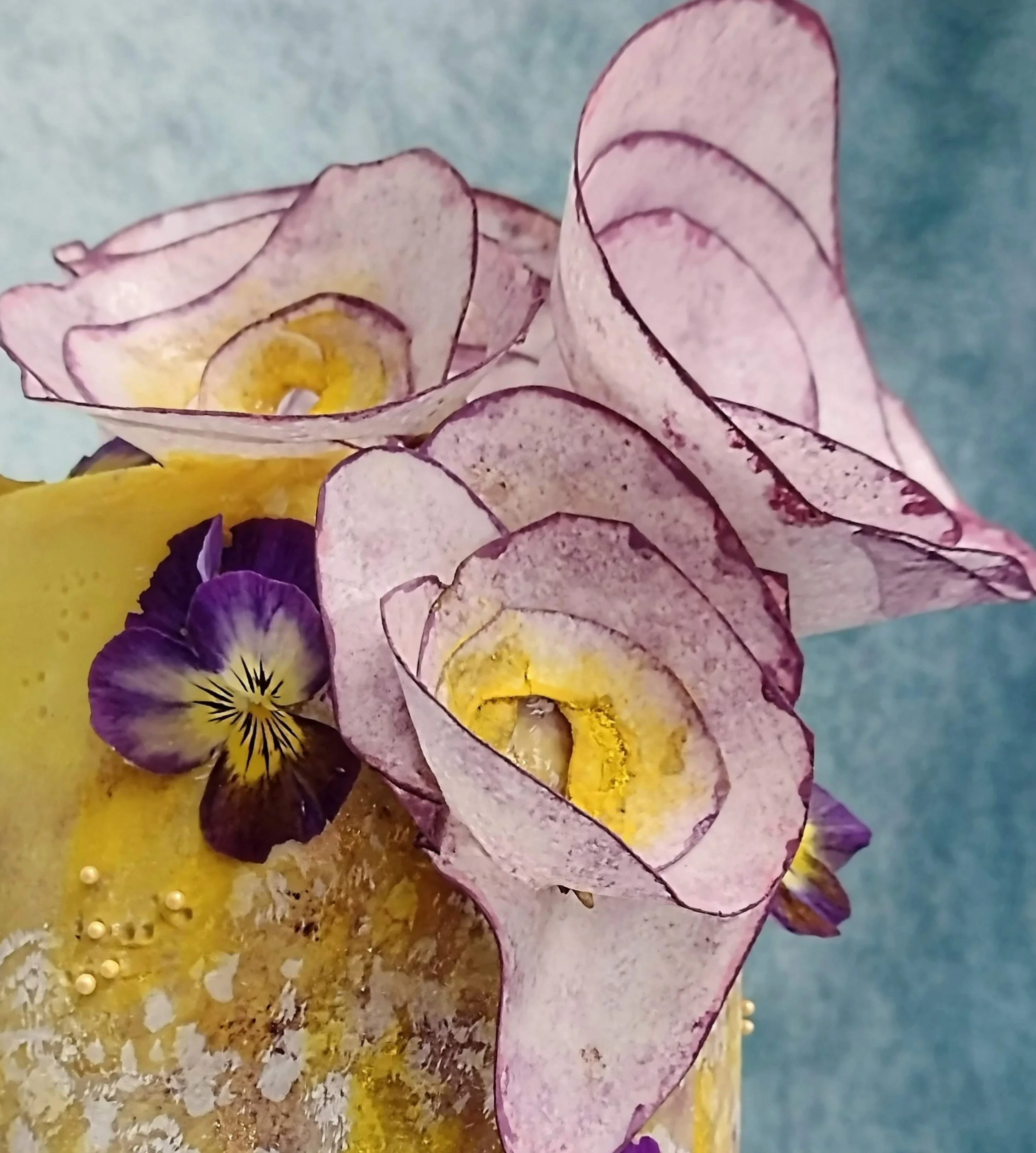 My two favourite garnish mediums - 'wafer paper' for creating abstract blooms, and -'organic edible flowers', late spring violas.
Complementing the clients brief of purple and yellow I finished the cake in a white chocolate ganache, tinted with natur