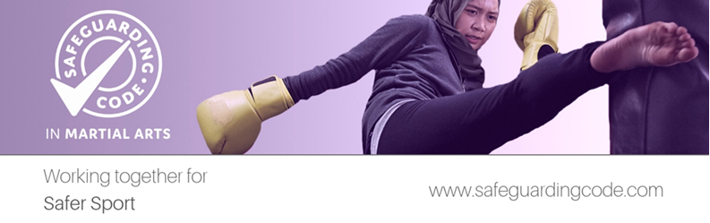 A woman practicing martial arts, wearing yellow gloves, kicking a protective padded target in a martial arts training setting with a purple background, promoting safe training in martial arts.