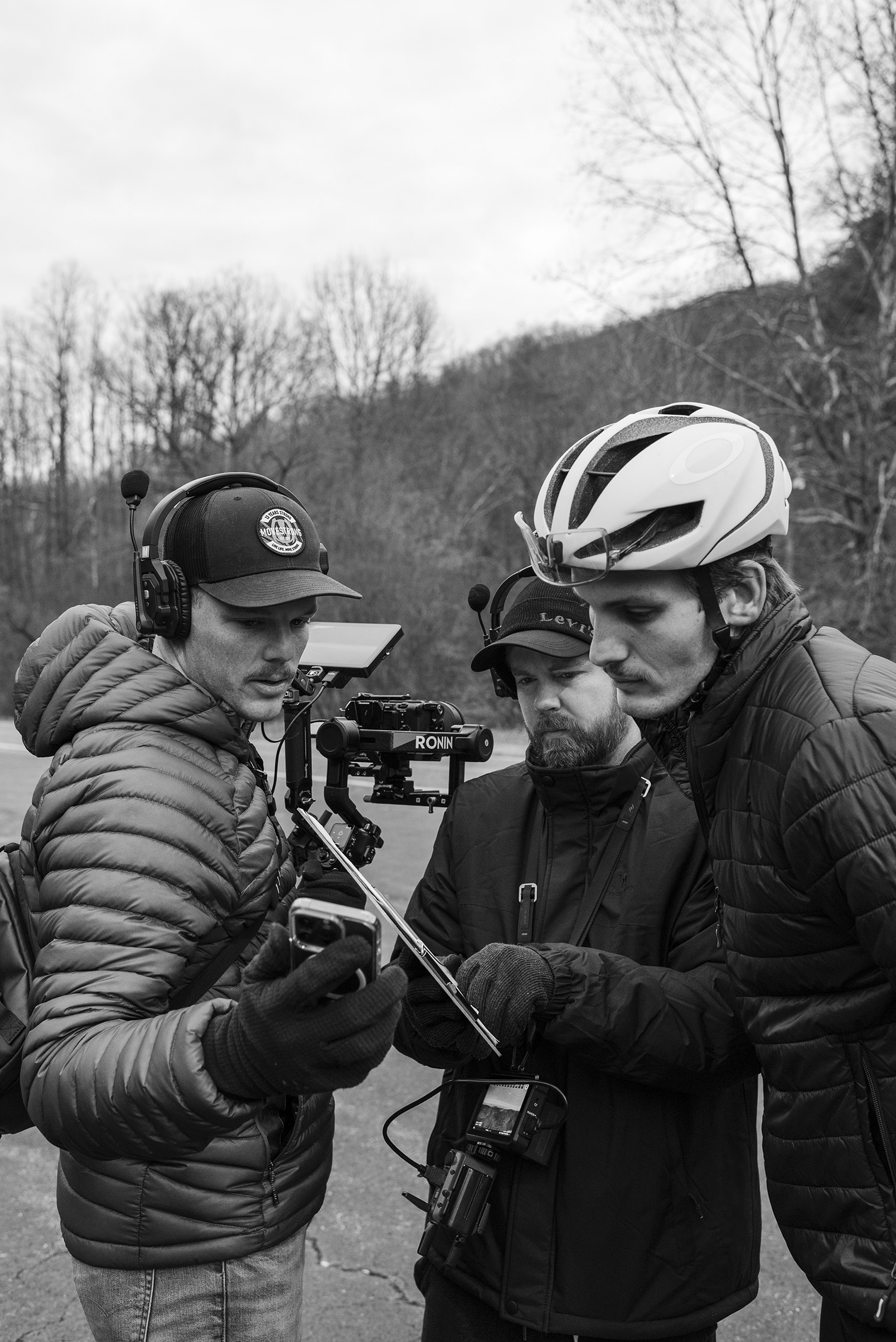 Filmmakers reviewing camera monitor and Ronin gimbal setup during professional video production