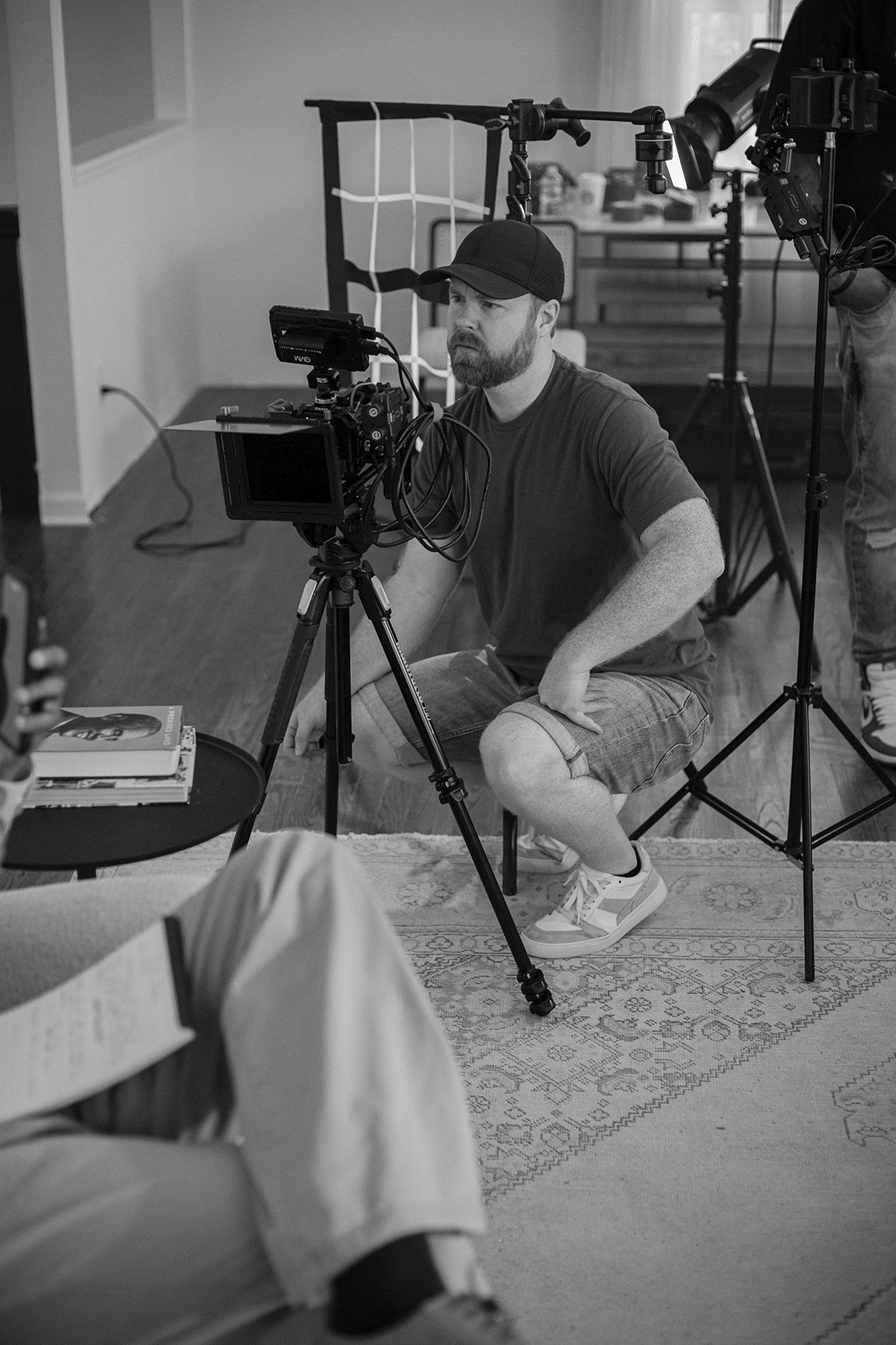 Professional videographer preparing camera and lighting for a commercial video production shoot