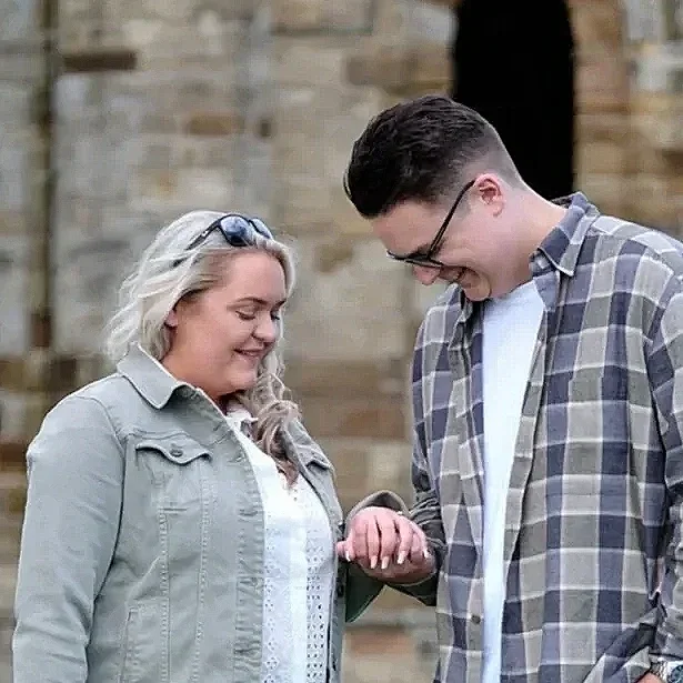 Couple looking at engagement ring