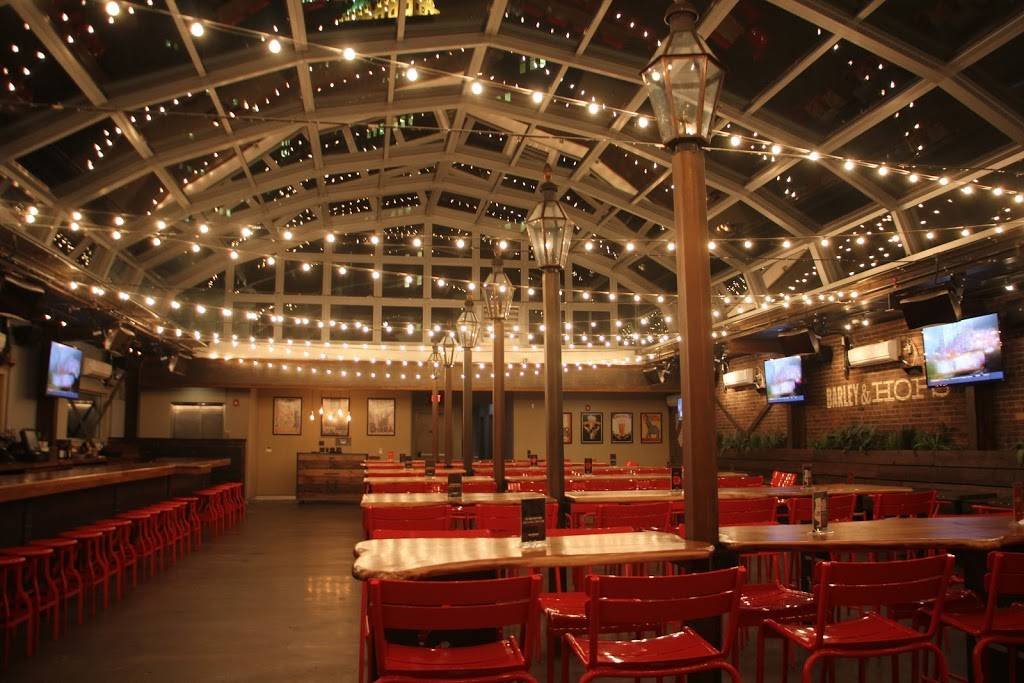 Sienna Mercato's rooftop beer garden at night decorated with white fairy lights strung across the roof windows.