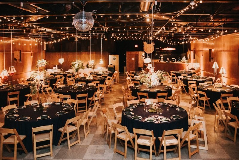Spirit decorated for a party with round tables, florals, a disco ball, and ambient lighting