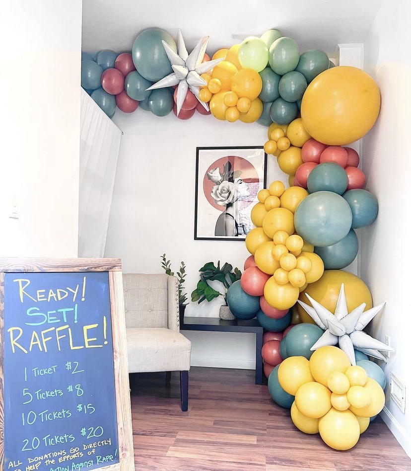 A colorful balloon garland with white starbursts